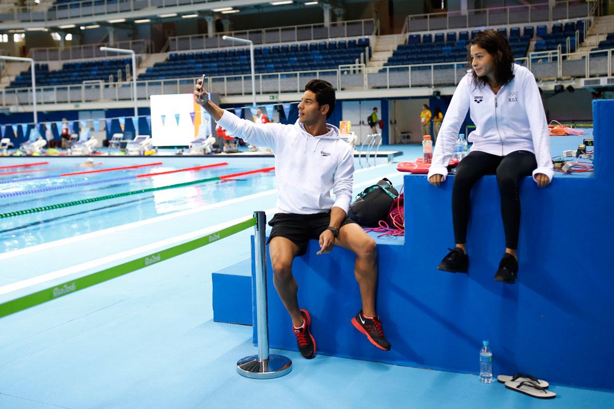 Syria's Rami Anys takes a selfie with Yusra Mardini after a training session at the Olympic Aquatics Stadium.