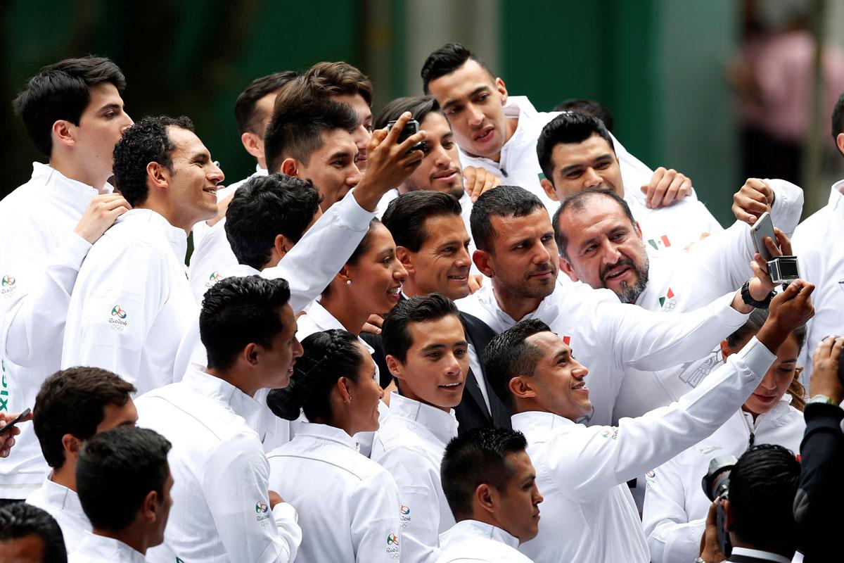 Mexico's President Enrique Pena Nieto poses for a selfie with Olympic athletes during a ceremony ahead of the Rio 2016 Olympic Games.