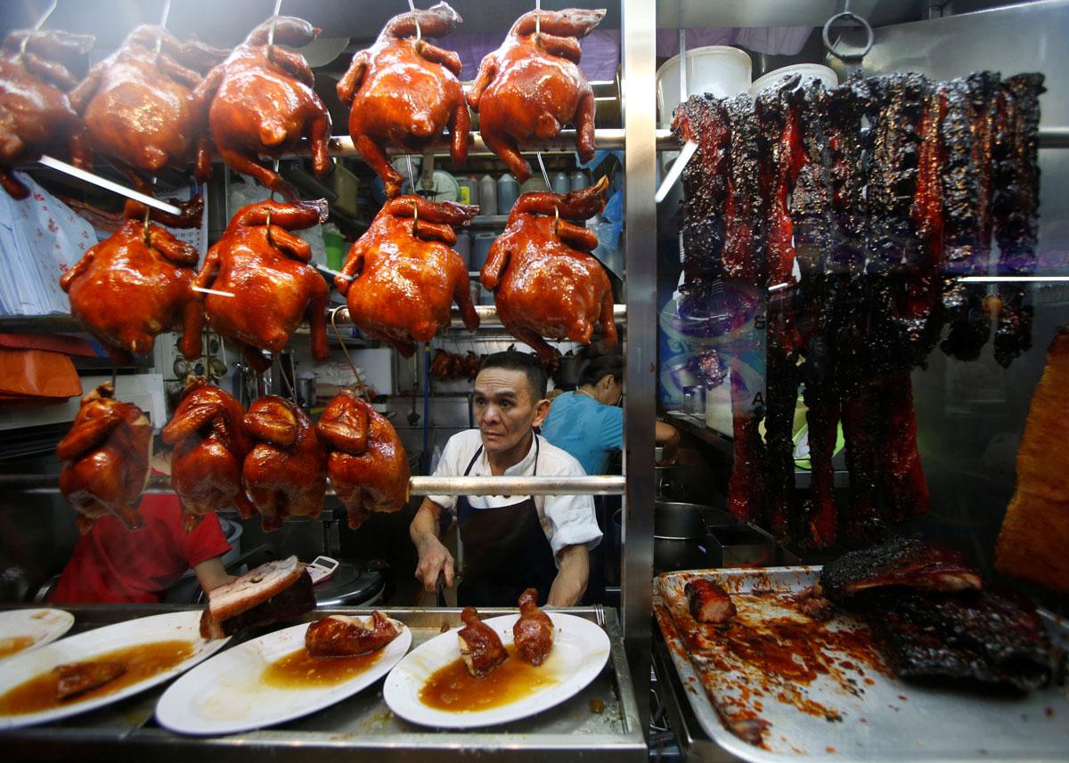 Hawker Chan Hong Meng, who won a Michelin star, sells soya sauce chicken at his Hong Kong Soya Sauce Chicken Rice and Noodle stall.