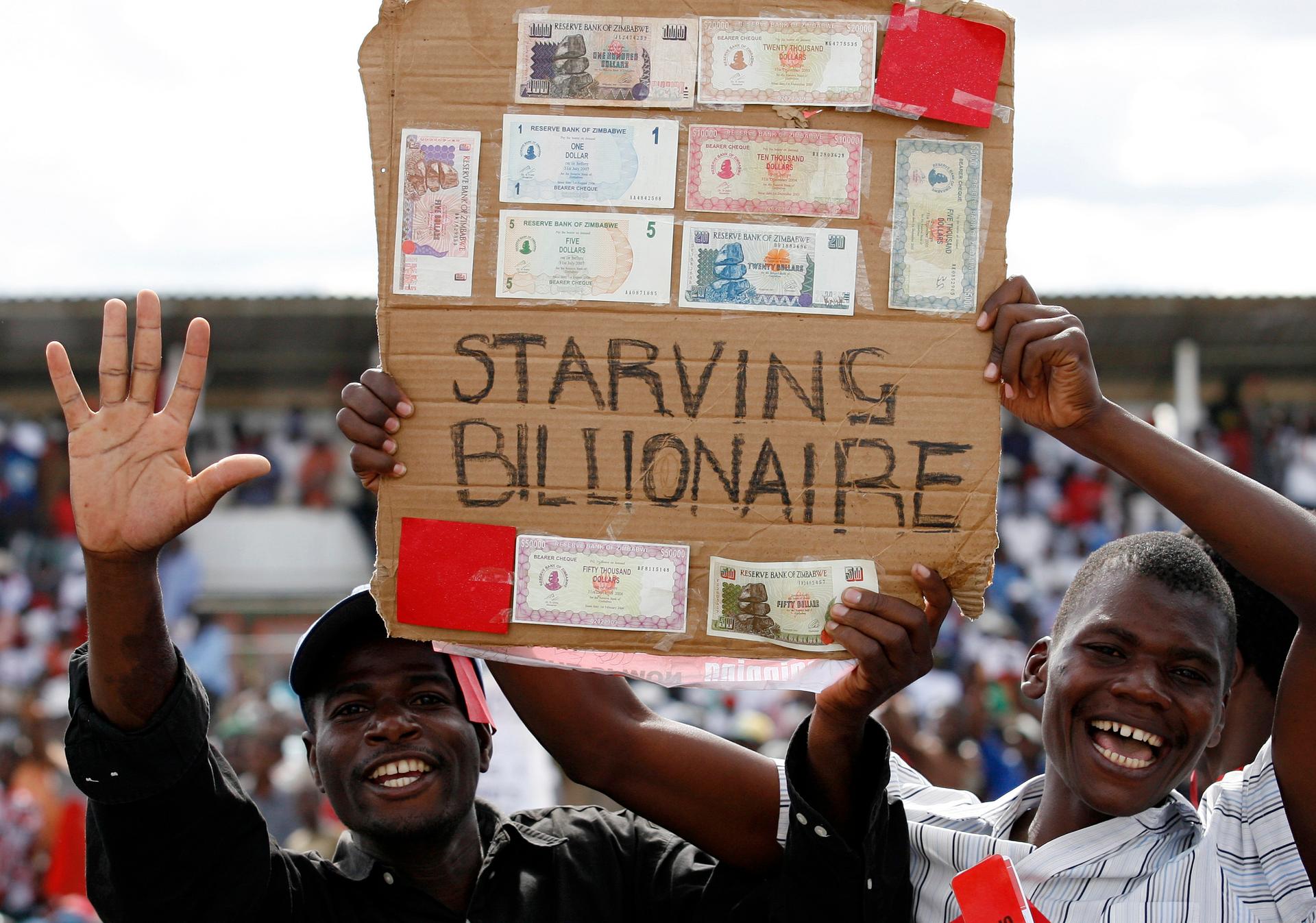 Zimbabwe protesters show old worthless bank notes near the capital Harare, 2008.