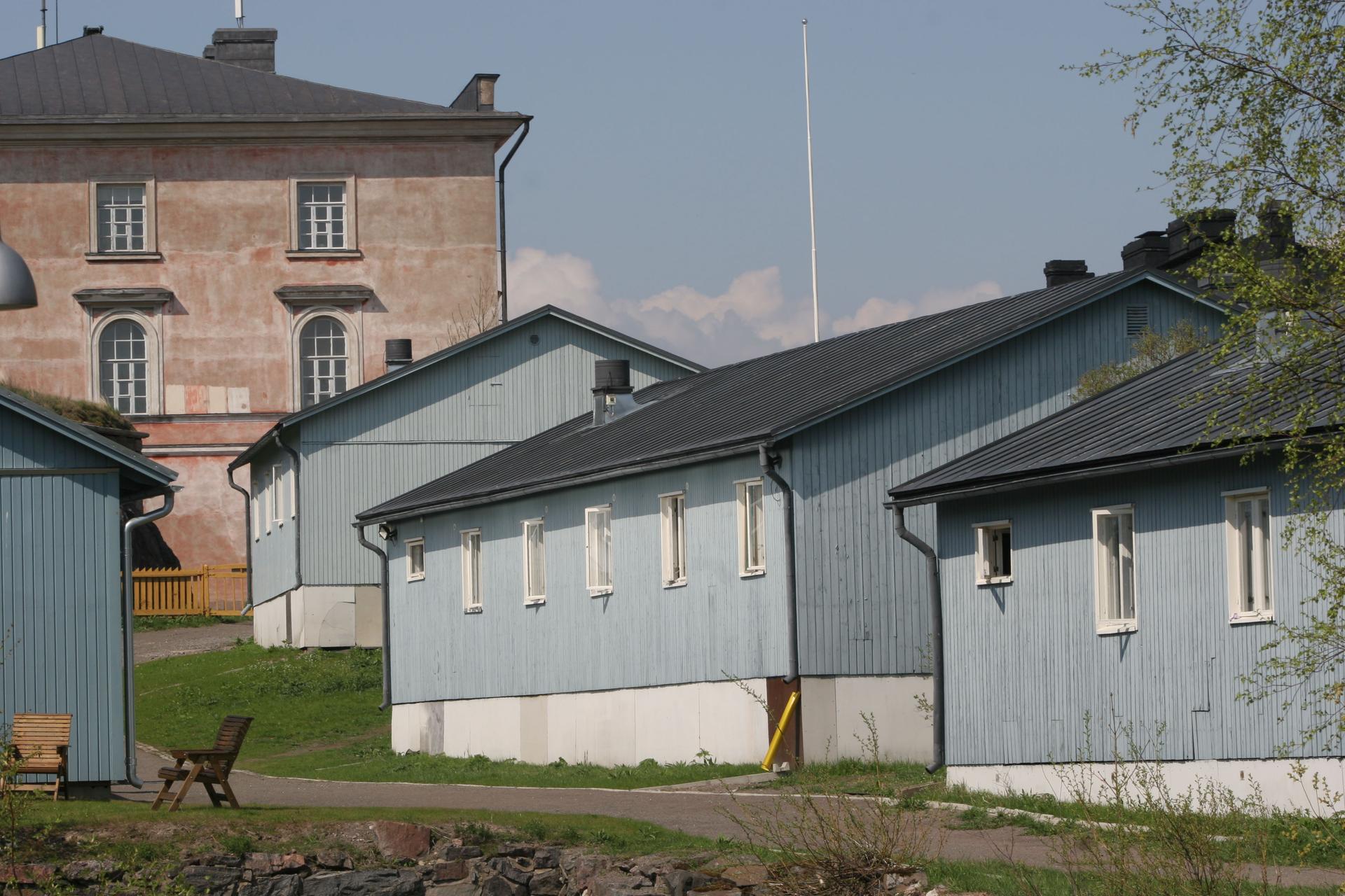 Inmates at the Suomenlinna open prison live in blue dormitory-style housing. A picket fence is all that separates the prison grounds from the rest of the island, a popular tourist destination.