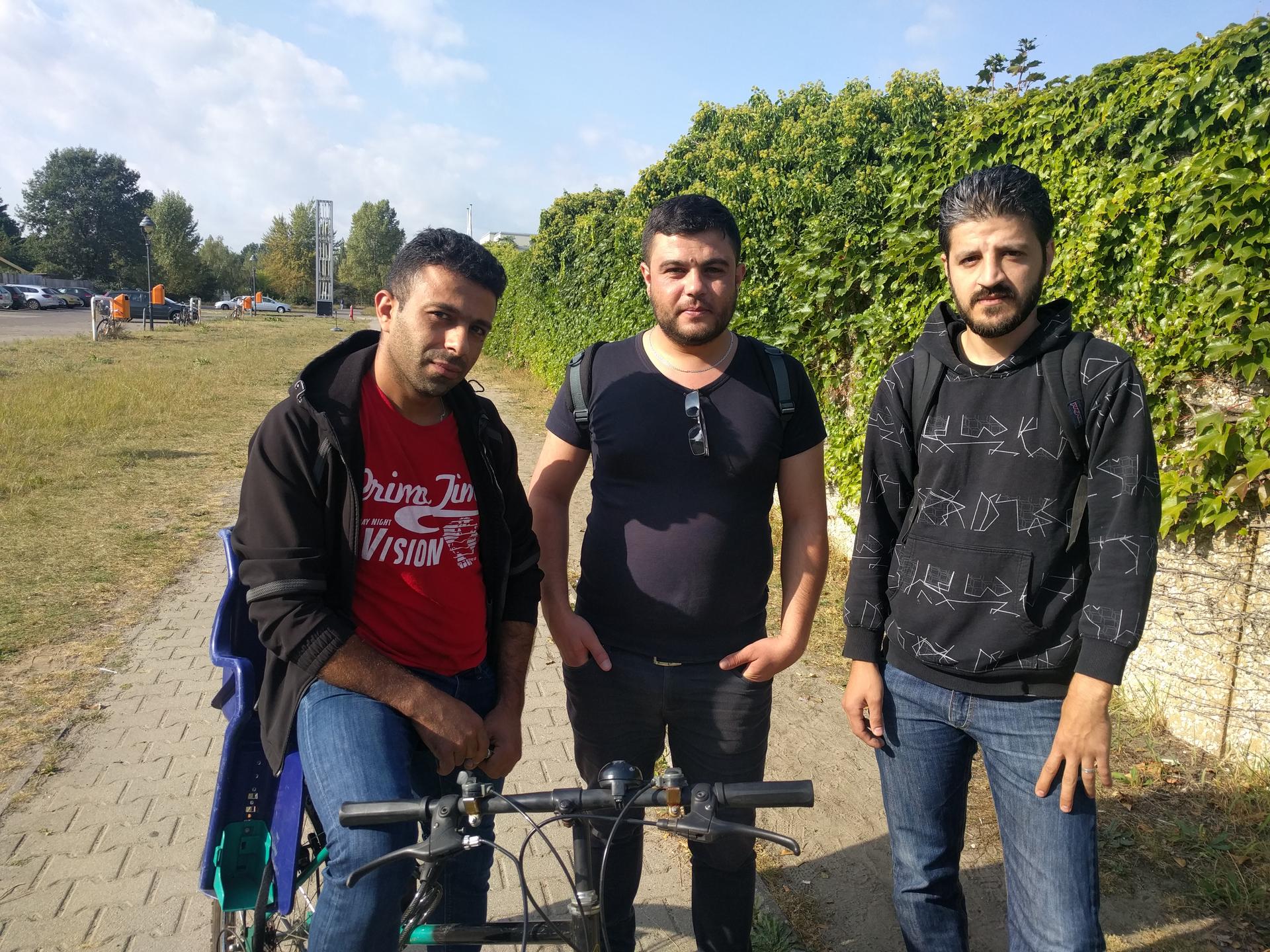 Syrian refugees escaping war back home, seek to make a new life in Berlin. Fadi, 28, a former car dealer in Hama, is in the middle; Ahmed, 28, a tailor from Aleppo, is on the right