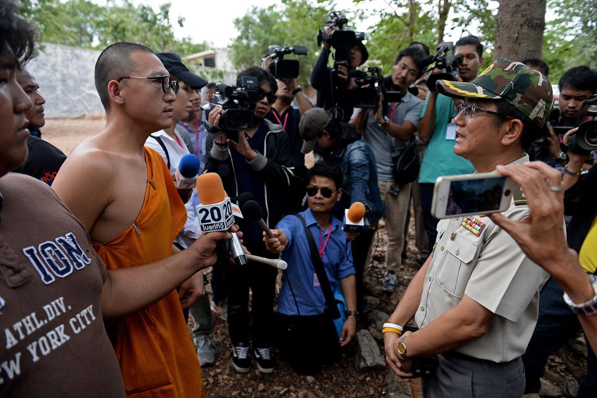 A Thai wildlife official speaks with a monk before officials removed tigers from enclosures at the Wat Pha Luang Ta Bua Tiger Temple in Kanchanaburi province, western Thailand.
