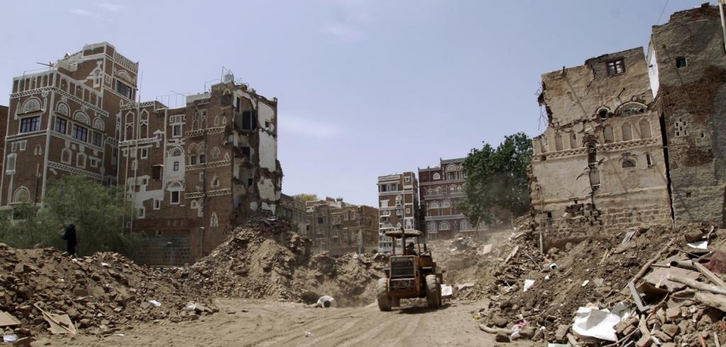 Yemenis clear the rubble of houses in the old city of Sanaa, a UNESCO-listed heritage site, on June 15, 2015, after an airstrike.