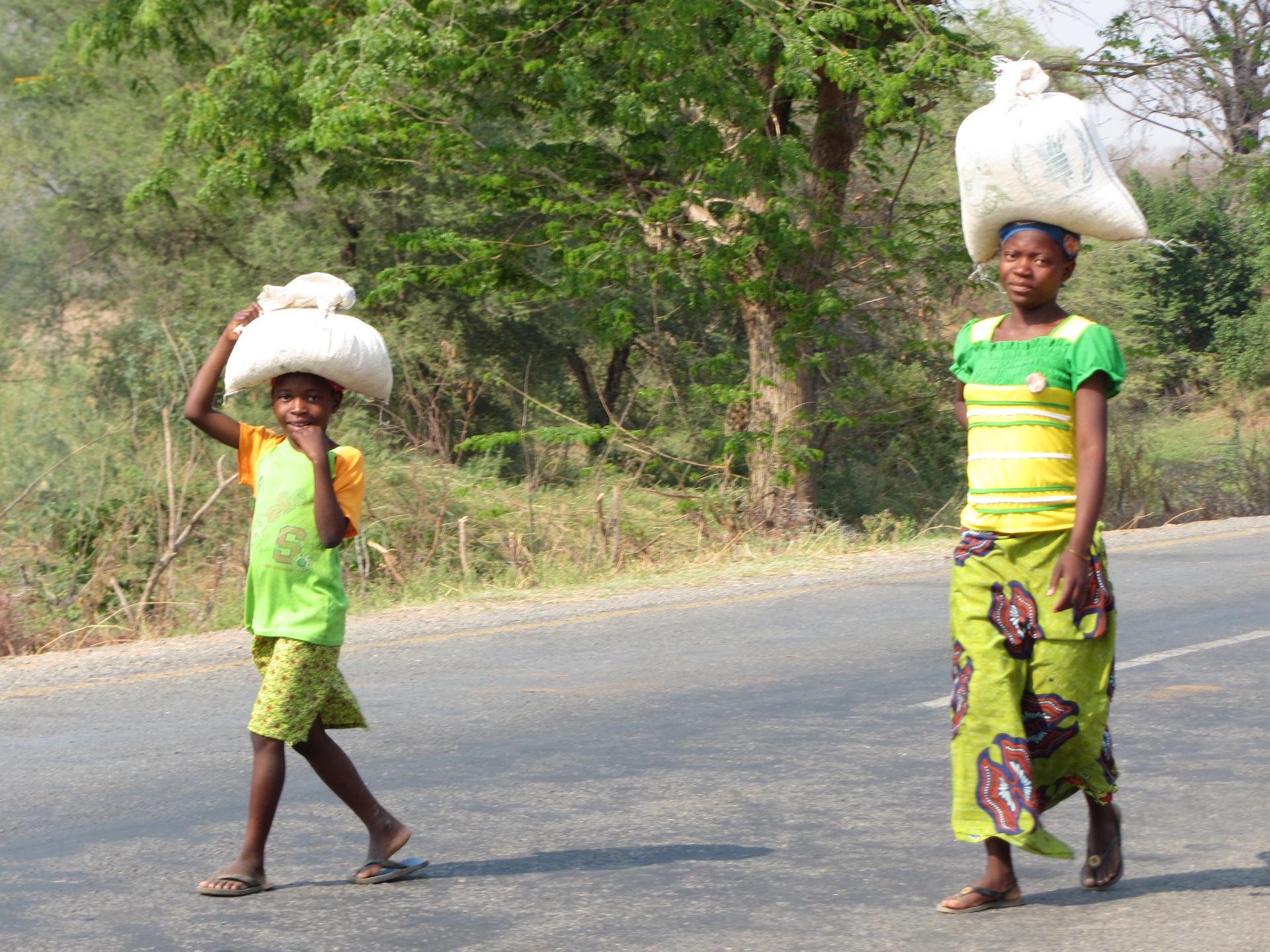 Zambians walking near their village