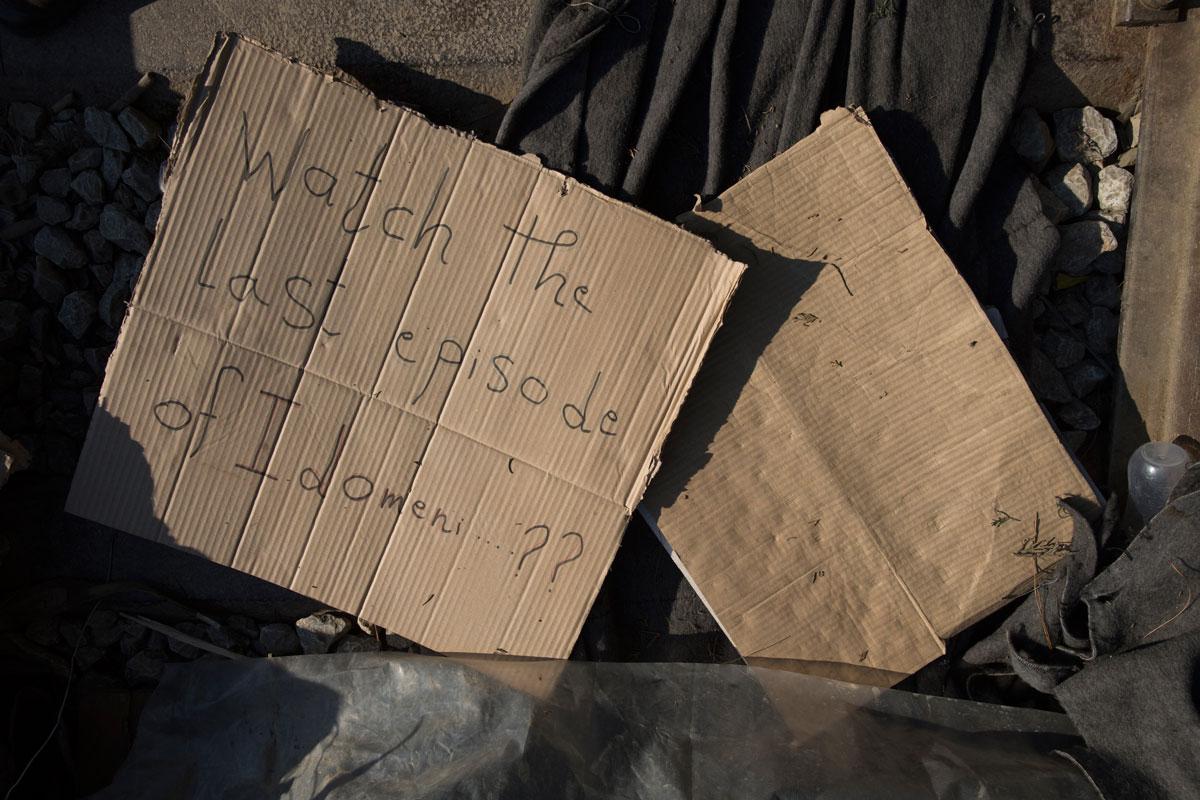 Protest signs among the debris left by immigrants after Greek authorities completed the evacuation of Idomeni Camp.
