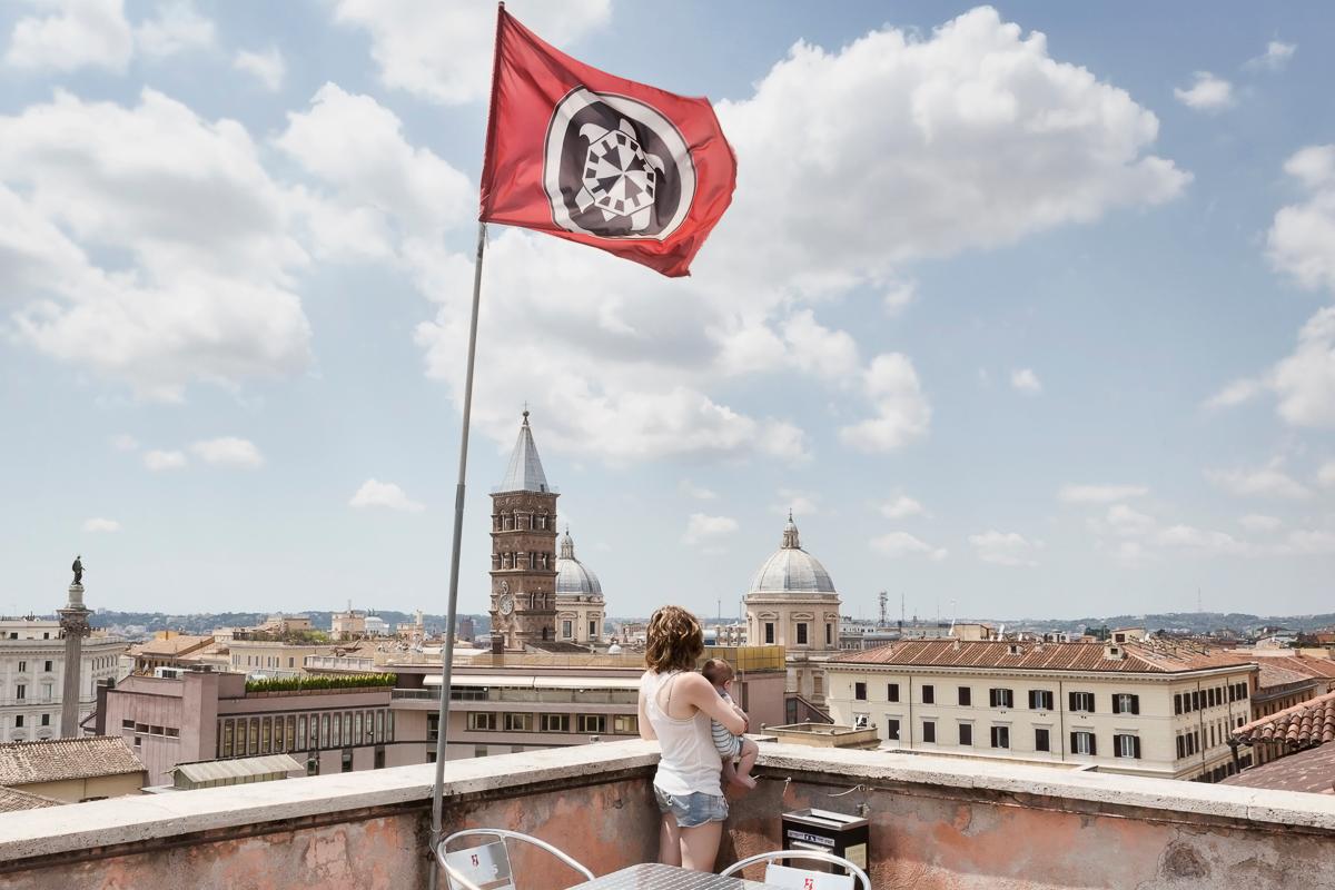 Estella and her four-month-old stare at Roman rooftops form the terrace of CasaPound. Once a government ministry building, today it is the headquarters of Italy’s biggest neo-Fascist movement. She and nearly 100 other CasaPound members live her as squatte