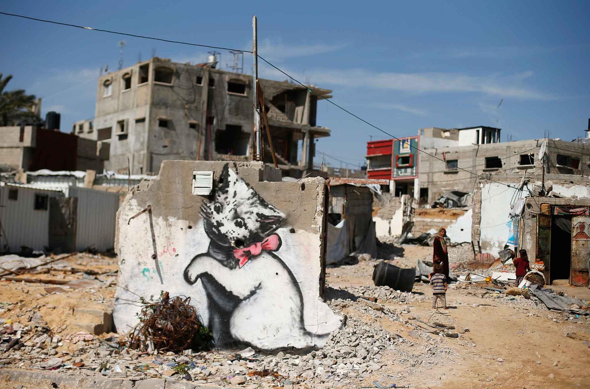 A mural of a playful-looking kitten, thought to be painted by British street artist Banksy, is seen on the remains of a house in Biet Hanoun. Banksy has posted a mini-documentary on his banksy.co.uk site showing squalid conditions in Gaza six months after