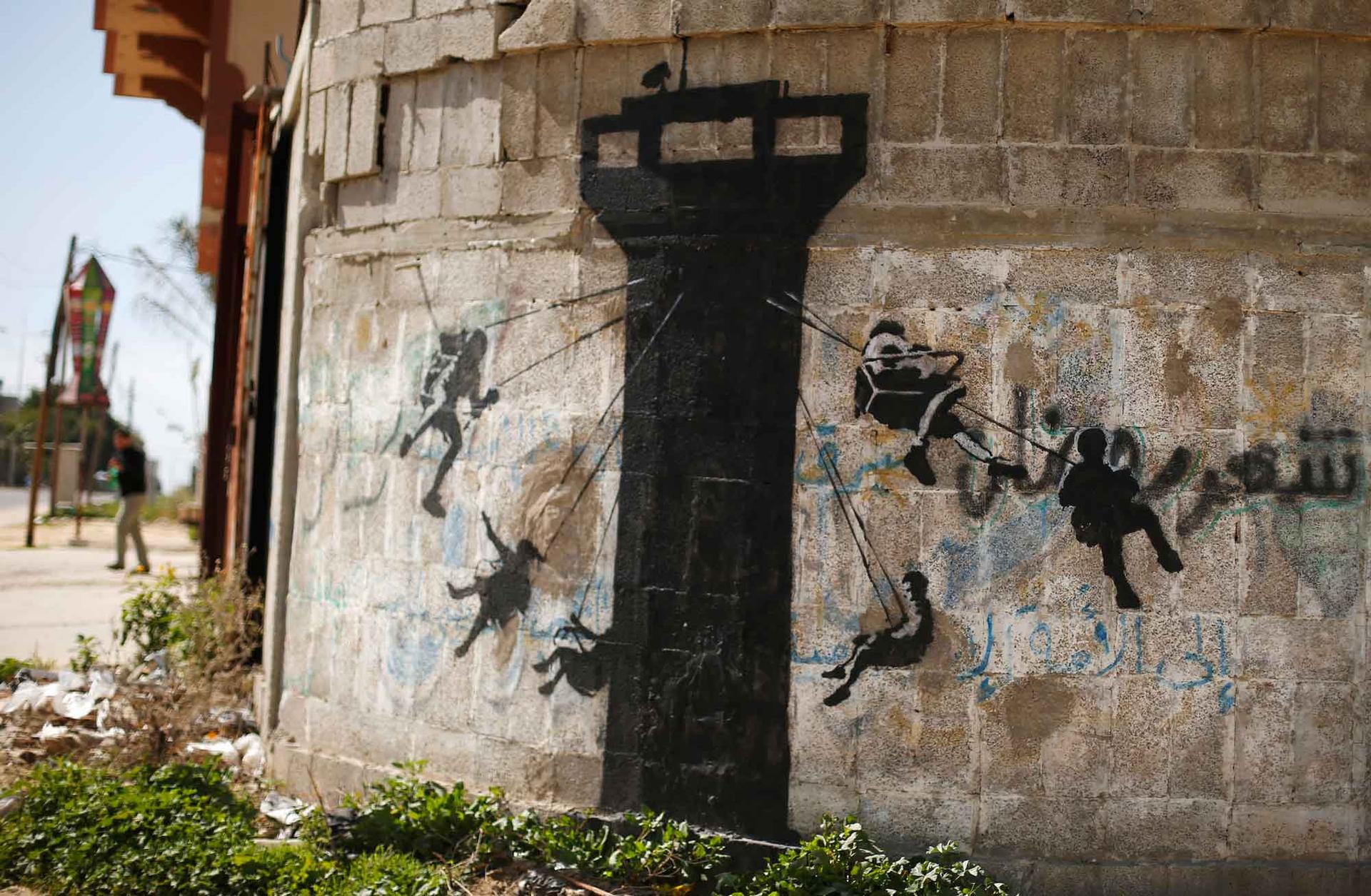 A mural, thought to be painted by British street artist Banksy, is seen on a wall in Biet Hanoun town in the northern Gaza Strip.