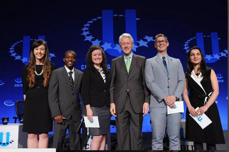 Mariam Adil (far right) onstage at a Clinton Global Initiative University's conference with President Bill Clinton and other commitment makers. Image courtesy GRID Website