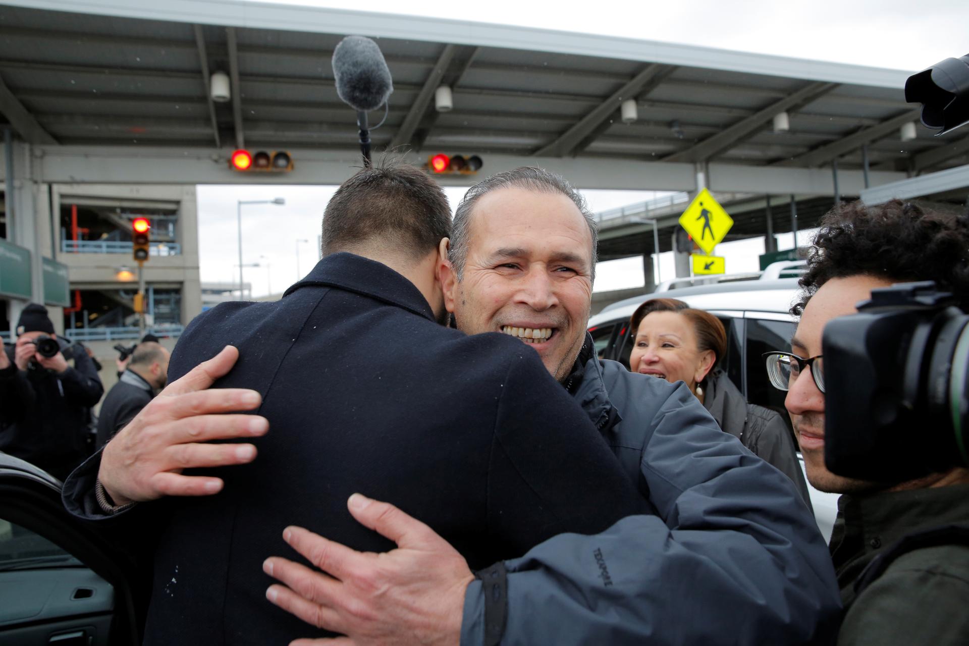 Hameed Darweesh, and Iraqi man who worked as a translator for the US Army, is embraced after being released at John F. Kennedy International Airport in Queens, New York, Jan. 28, 2017.