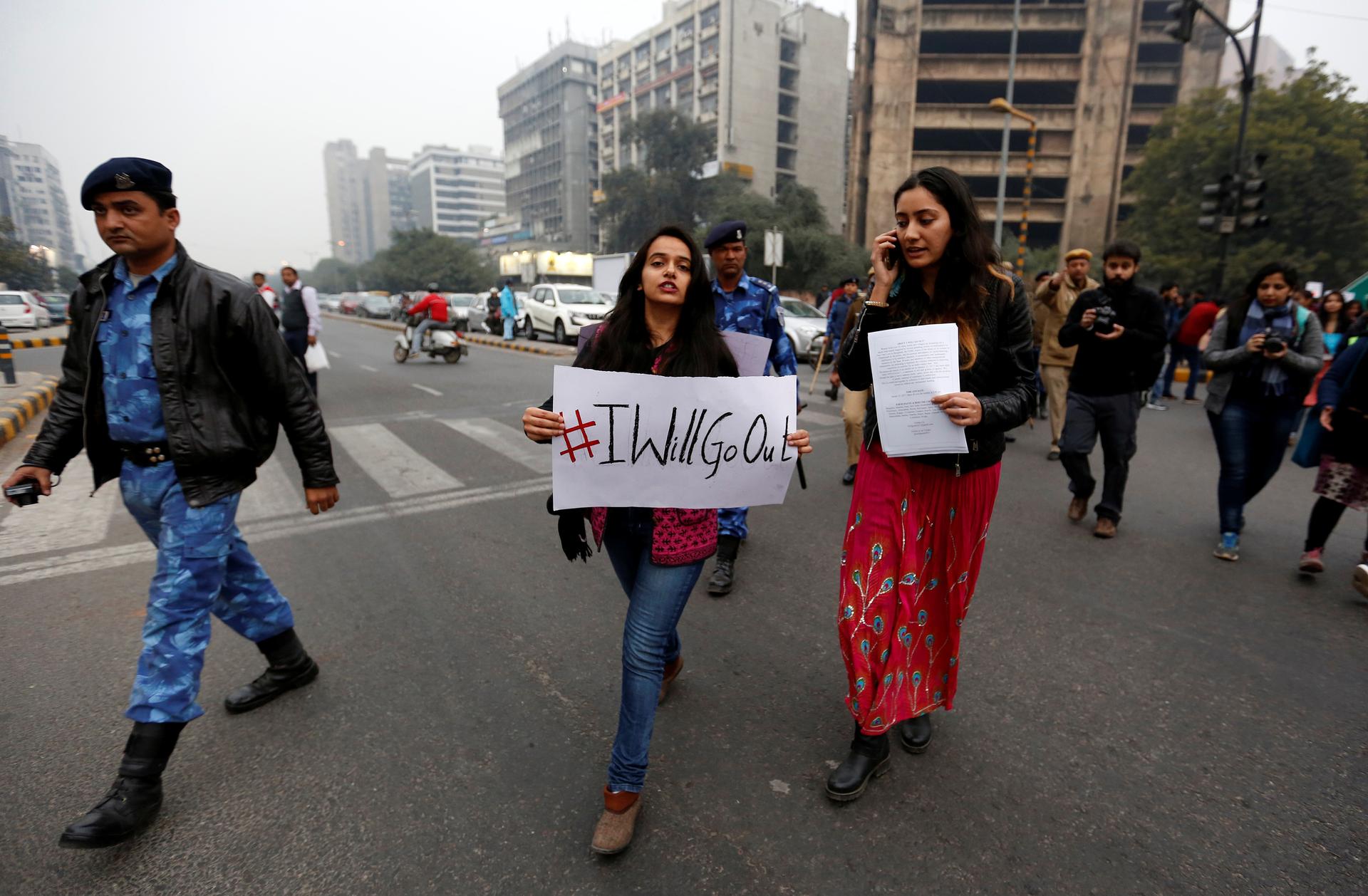 Women take part in the #IWillGoOut rally, organized to show solidarity with the Women's March in Washington, along a street in New Delhi, India