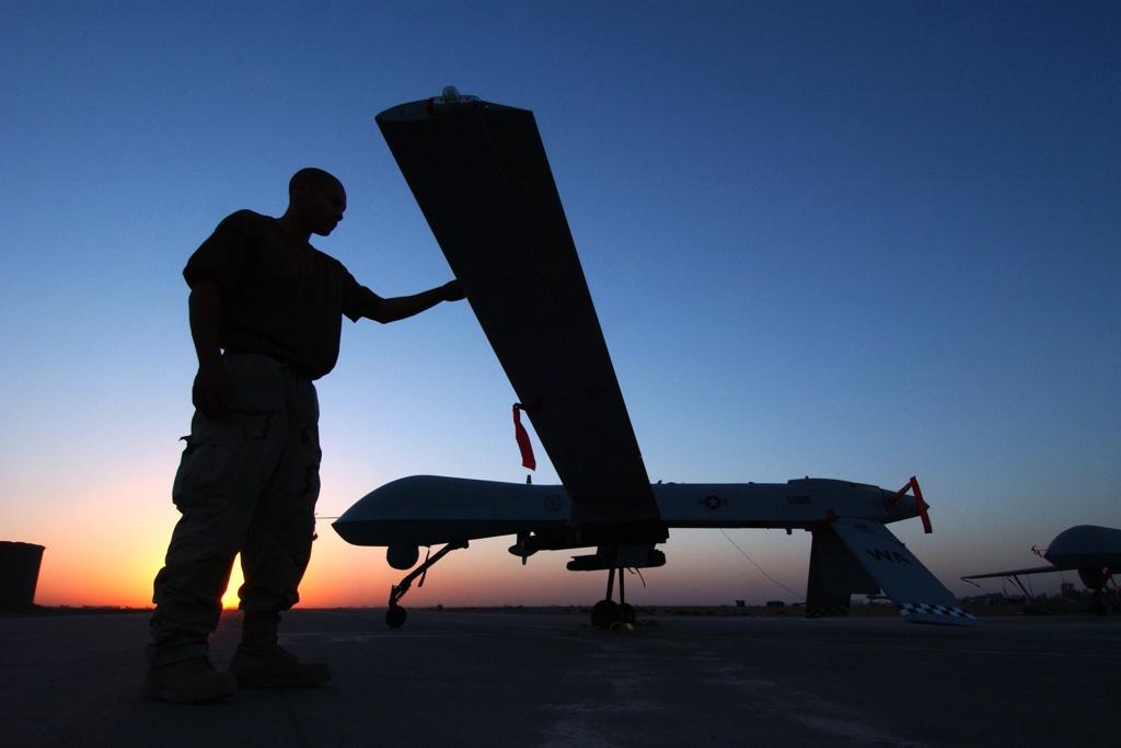 A crew chief completes a post flight inspection of a Predator drone on Sept. 15, 2004 at Balad Air Base, Iraq.
