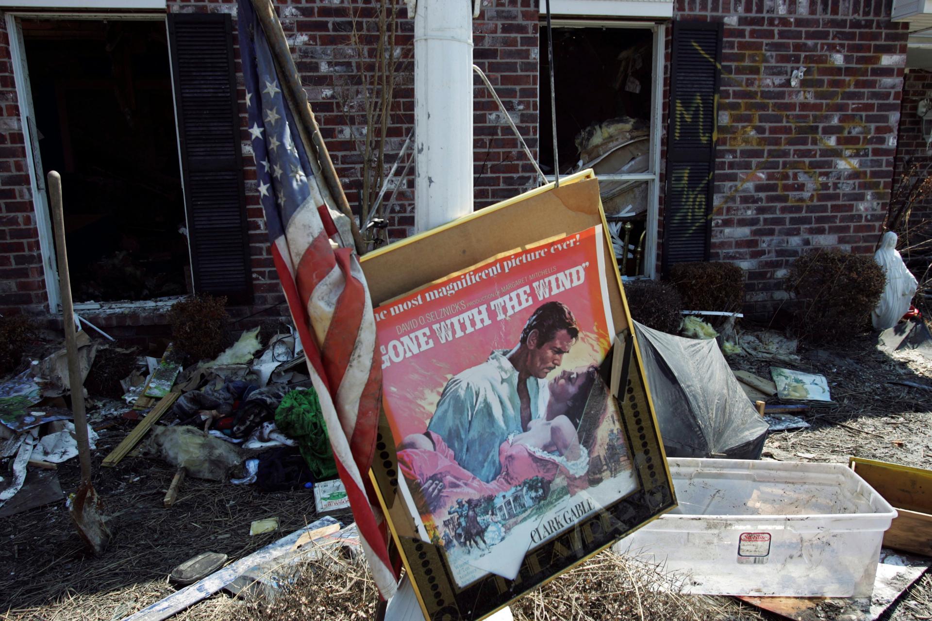 A movie poster for "Gone with the Wind" sits in a front yard of a home damaged by Hurricane Katrina in Chalmette, Louisiana, in St. Bernard Parish September 28, 2005.