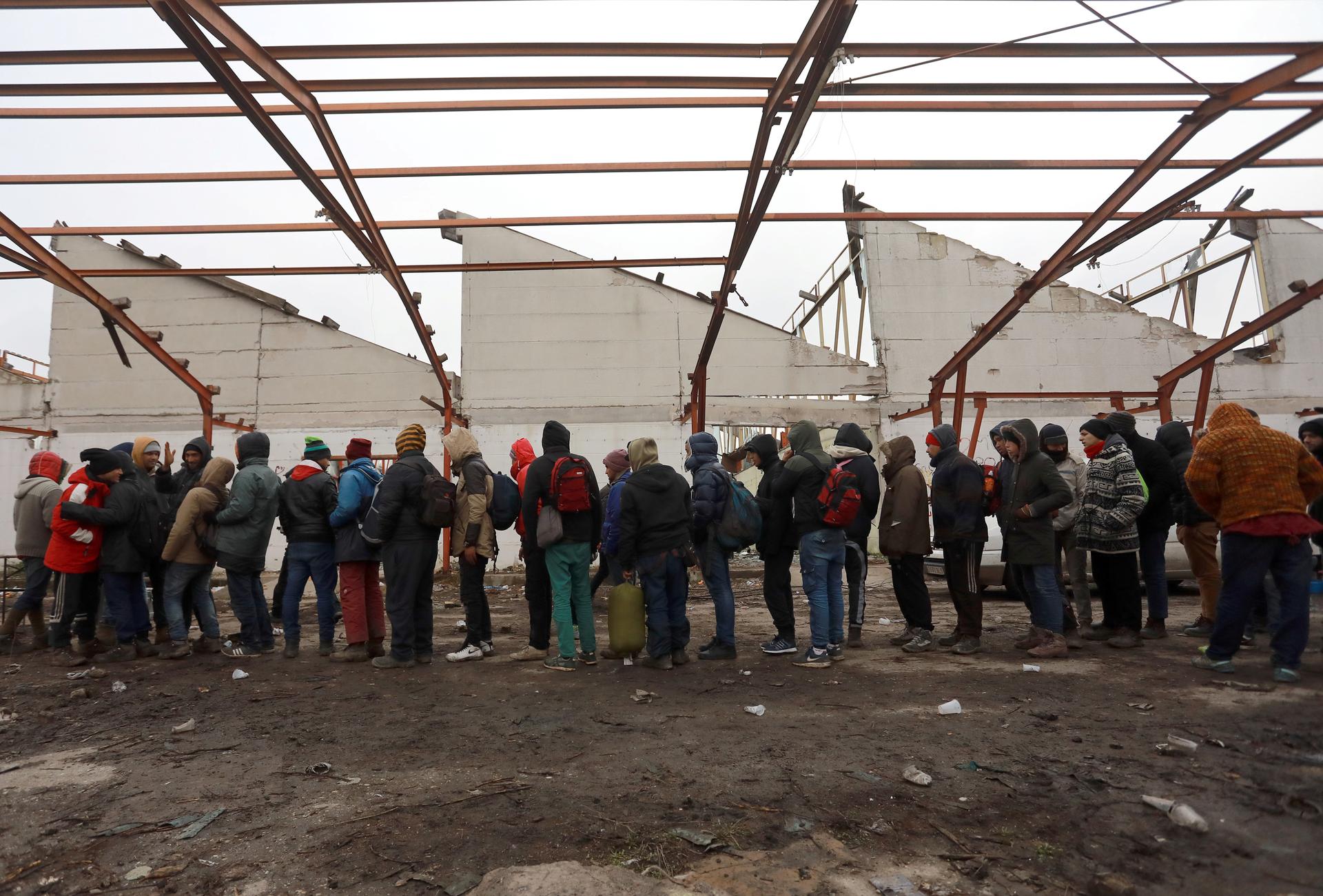 Migrants wait to receive food inside an abandoned factory close to the Croatian border near the town of Sid, Serbia, Dec. 19, 2017. Thousands of migrants and refugees remain stranded in the country. Iraqis and Syrians have the best chances of being grante