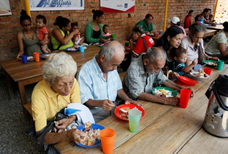 Venezuelans have a meal at a dining facility organised by Caritas and the Catholic church, in Cúcuta, Colombia, Feb. 21, 2018.