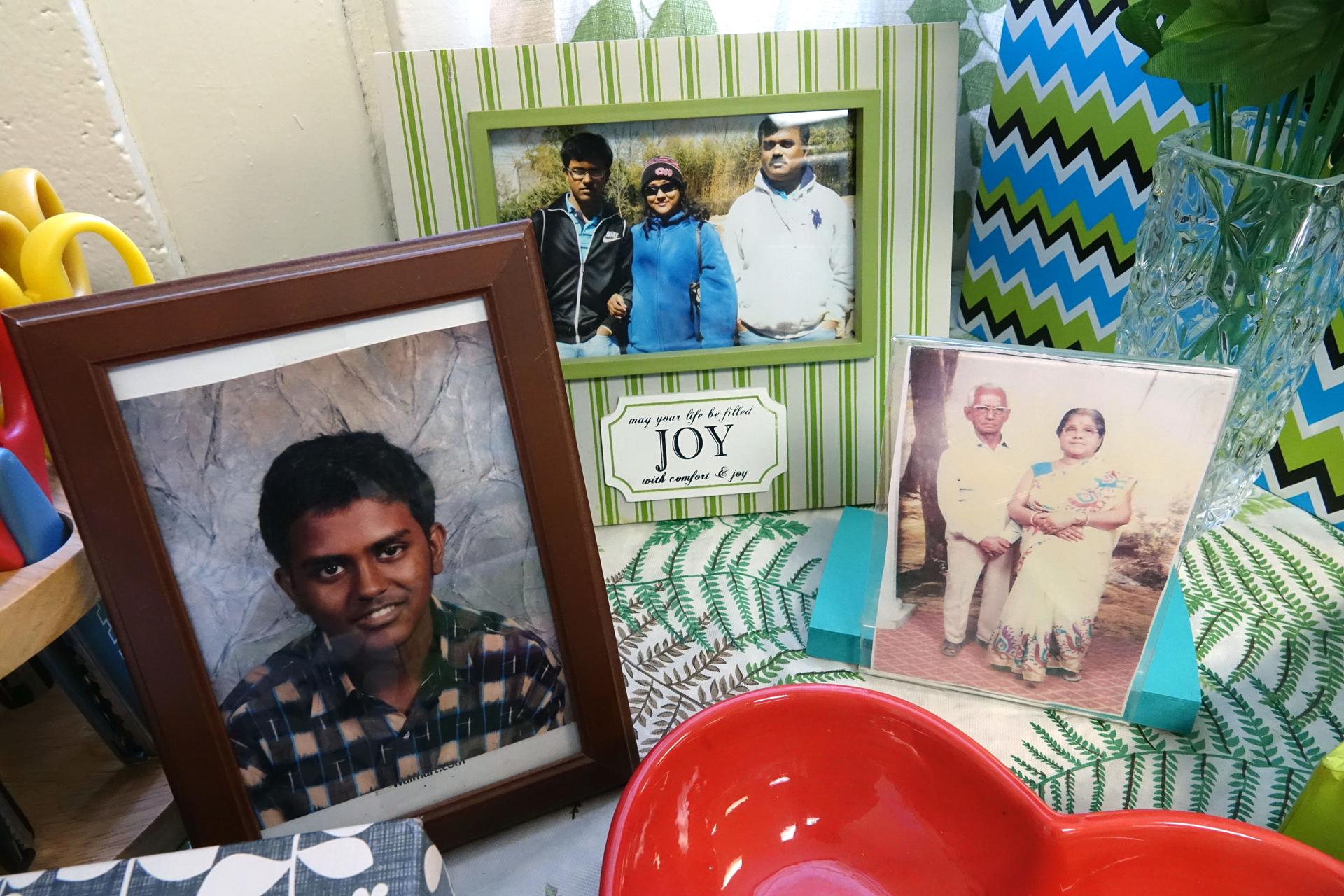 Photo frames with pictures of young boy, elderly couple, family