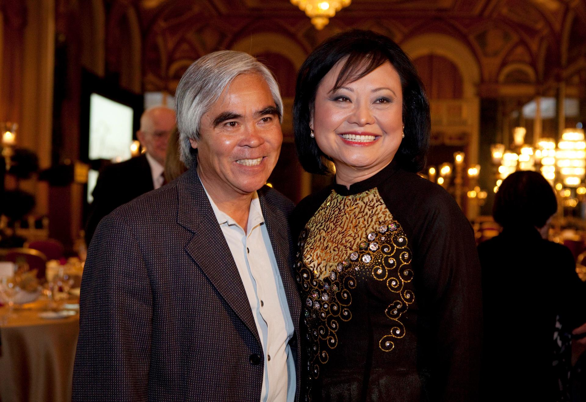 Photojournalist Nick Ut and Kim Phuc Phan Thi pose for pictures at the 