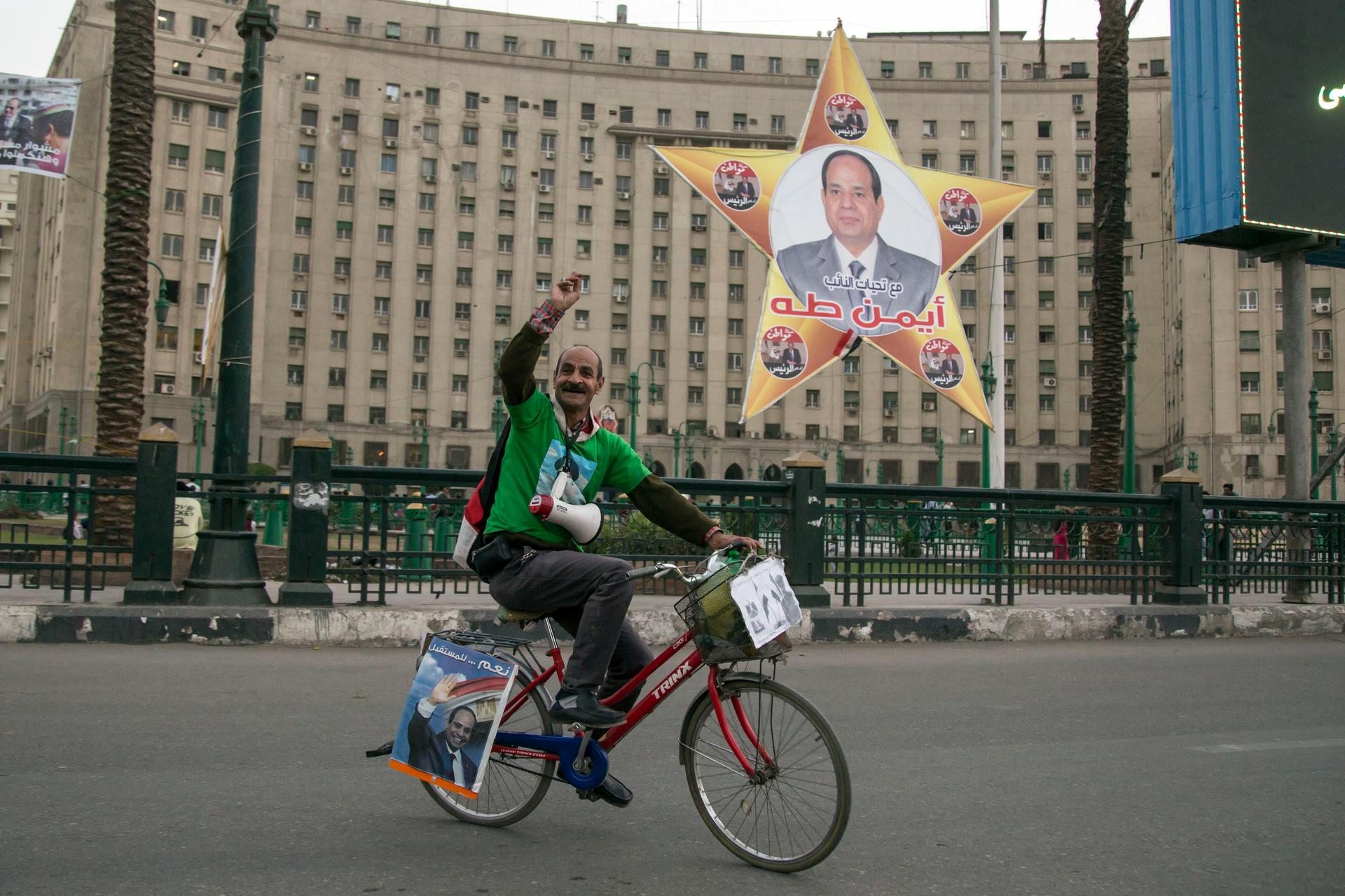 A supporter of Abdel Fatteh el-Sisi campaigns for the president in Tahrir Square ahead of the election today.