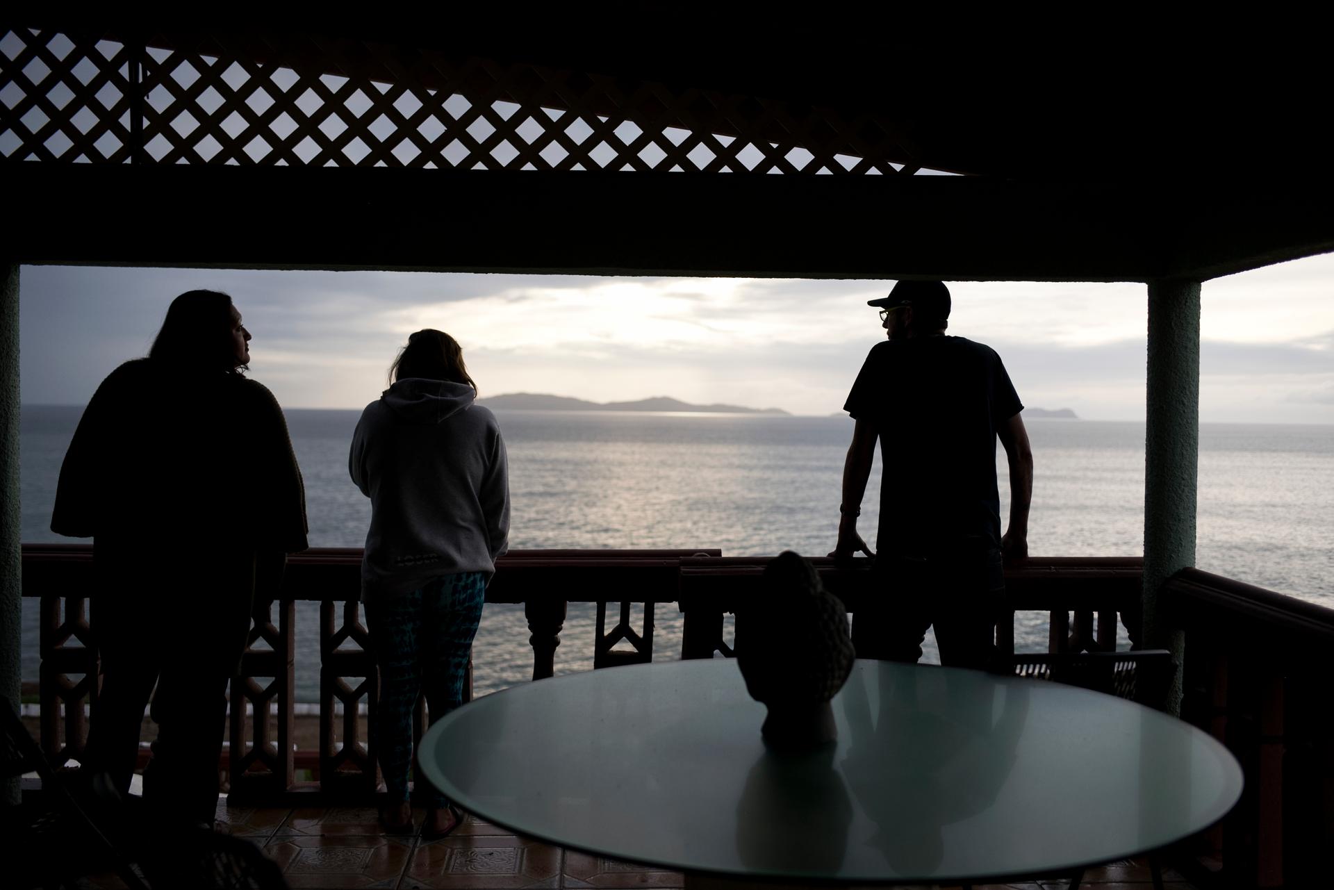 Staff at The Ibogaine Institute, an opioid rehab clinic, look at whales swimming off the Baja coast