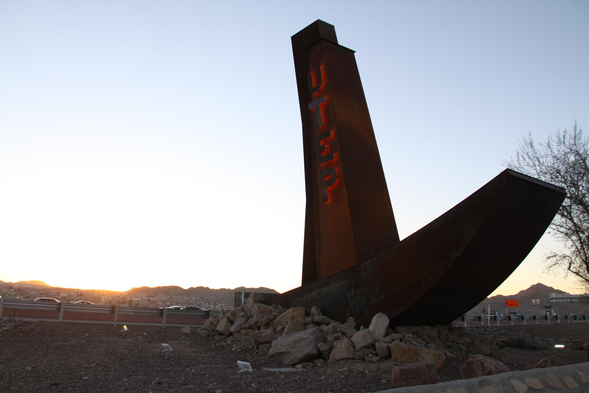 A photo of a UTEP sign right along the US-Mexico border.