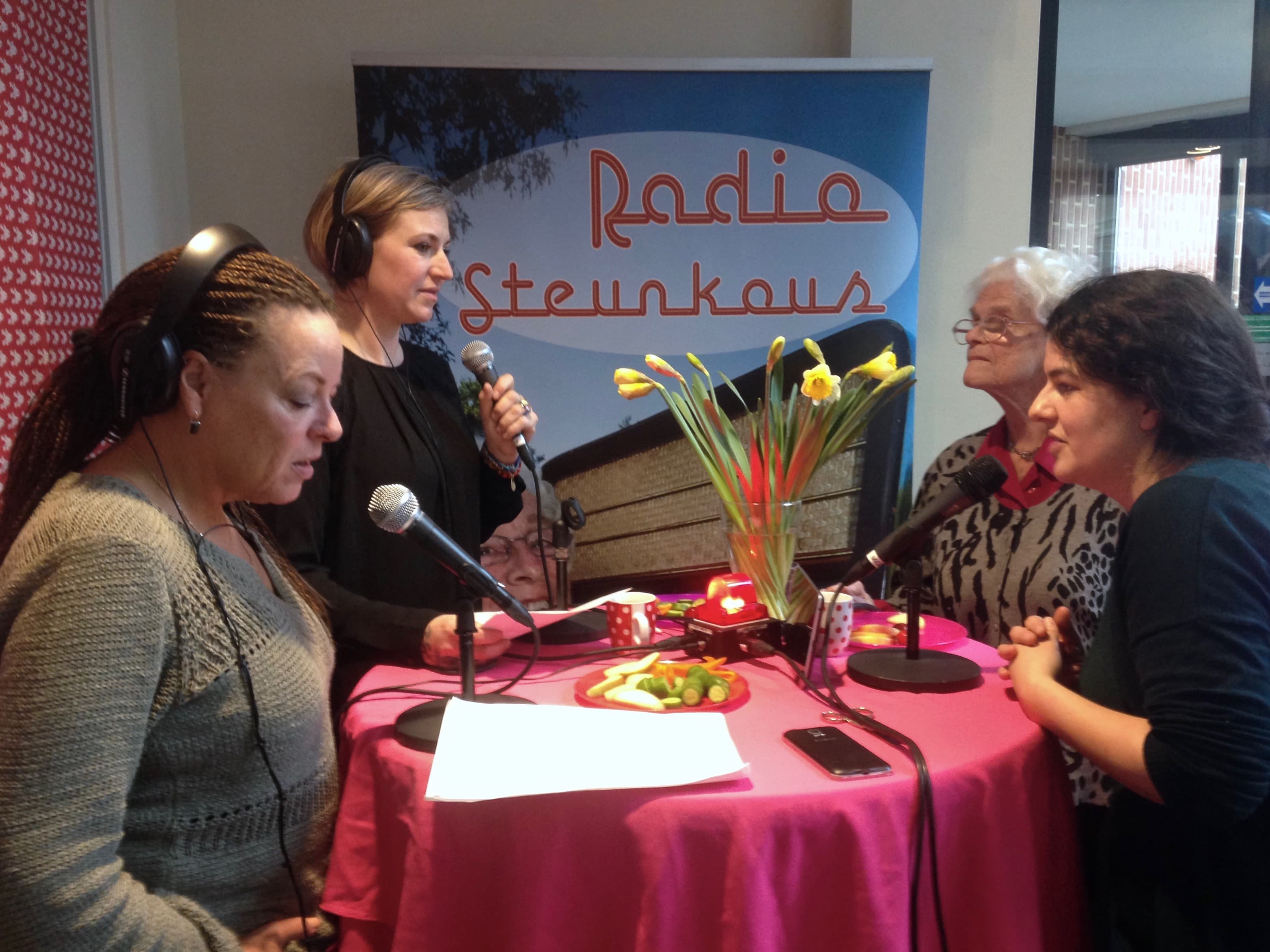 Presenter Elly Lakerveld (far left) checks her notes during a special edition of Radio Steunkous recorded in an Amsterdam health clinic.