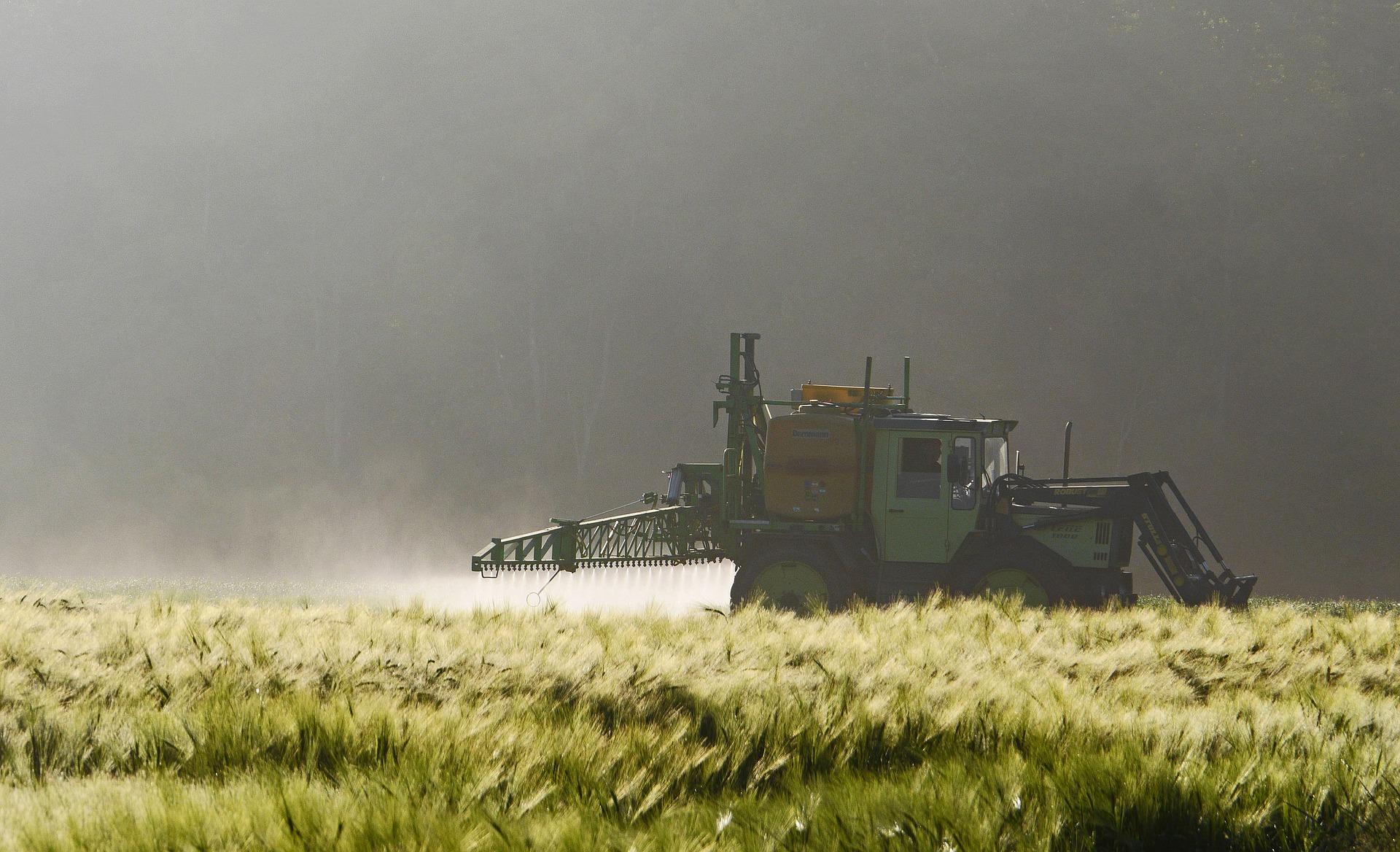 Farm tractor spraying crops.