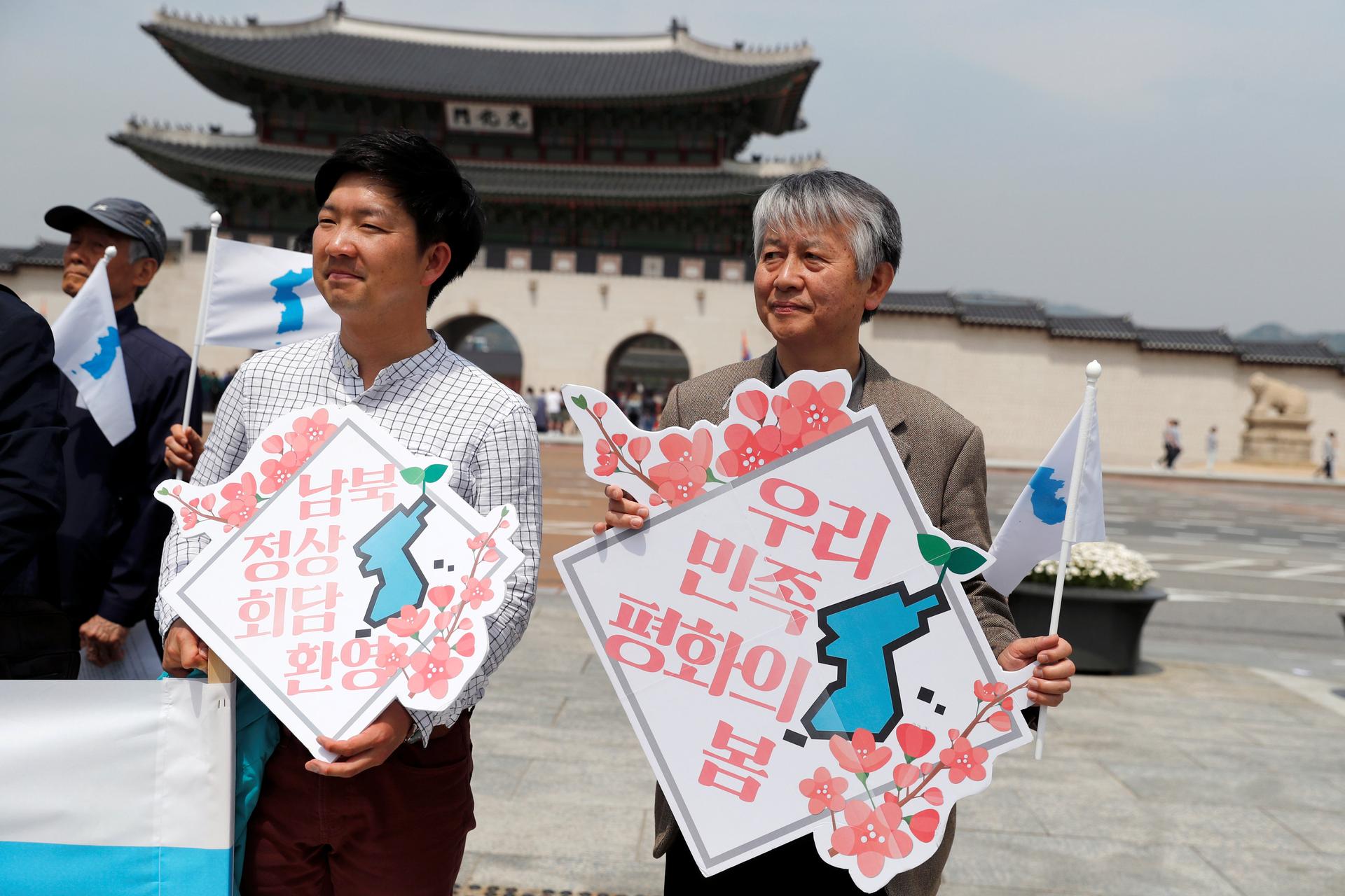 People hold Korean Unification Flags