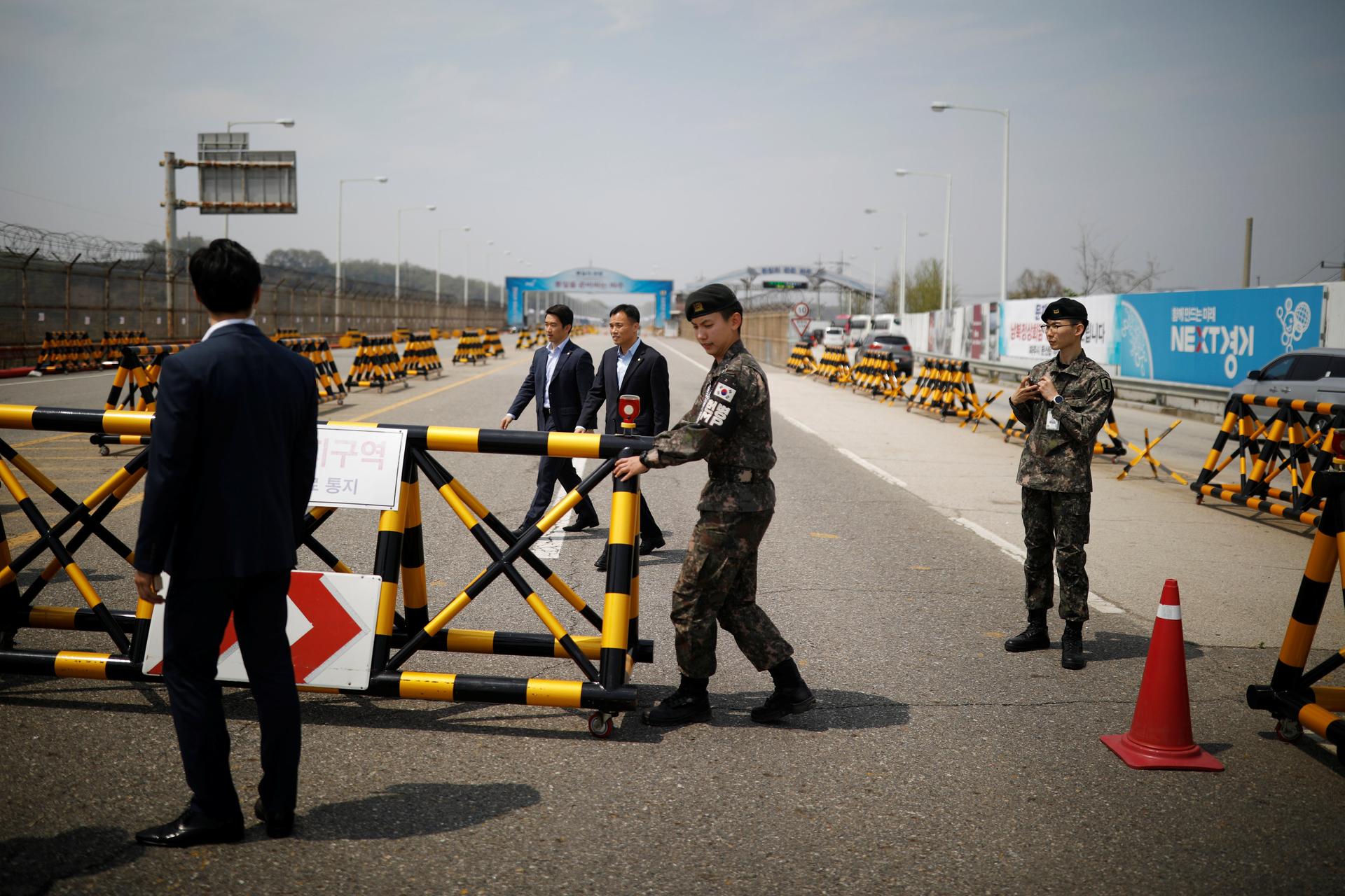 South Korean soldiers and security personnel stand guard at a checkpoint