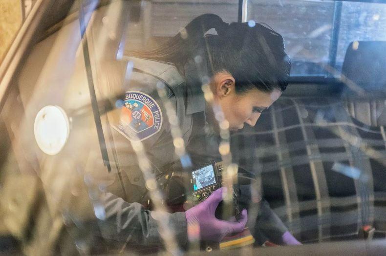 A police officer searches inside a stolen pick-up truck where BouKaram's cameras and other belongings were recovered after his RV was stolen in Albuquerque, NM.