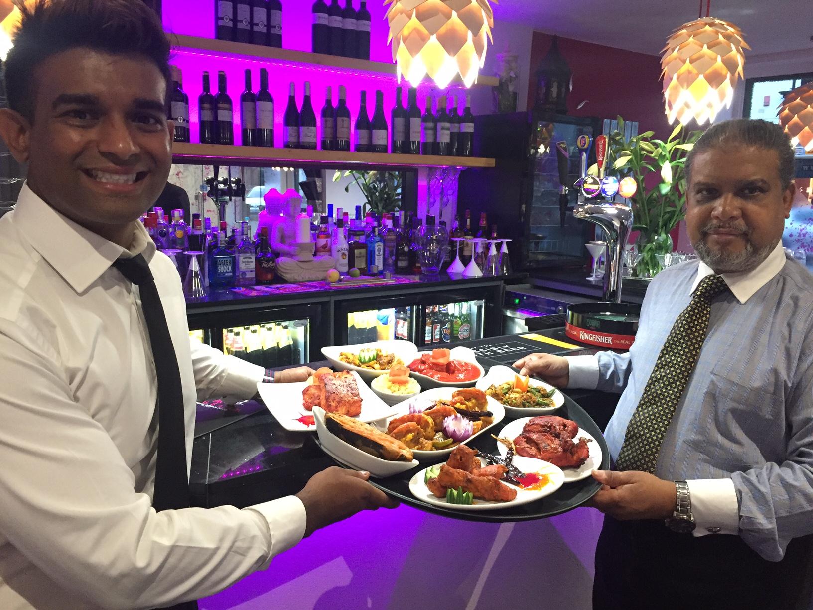 Sujat Sheikh, right, and his son at their restaurant called Mogul E Azam in Nottingham, England.