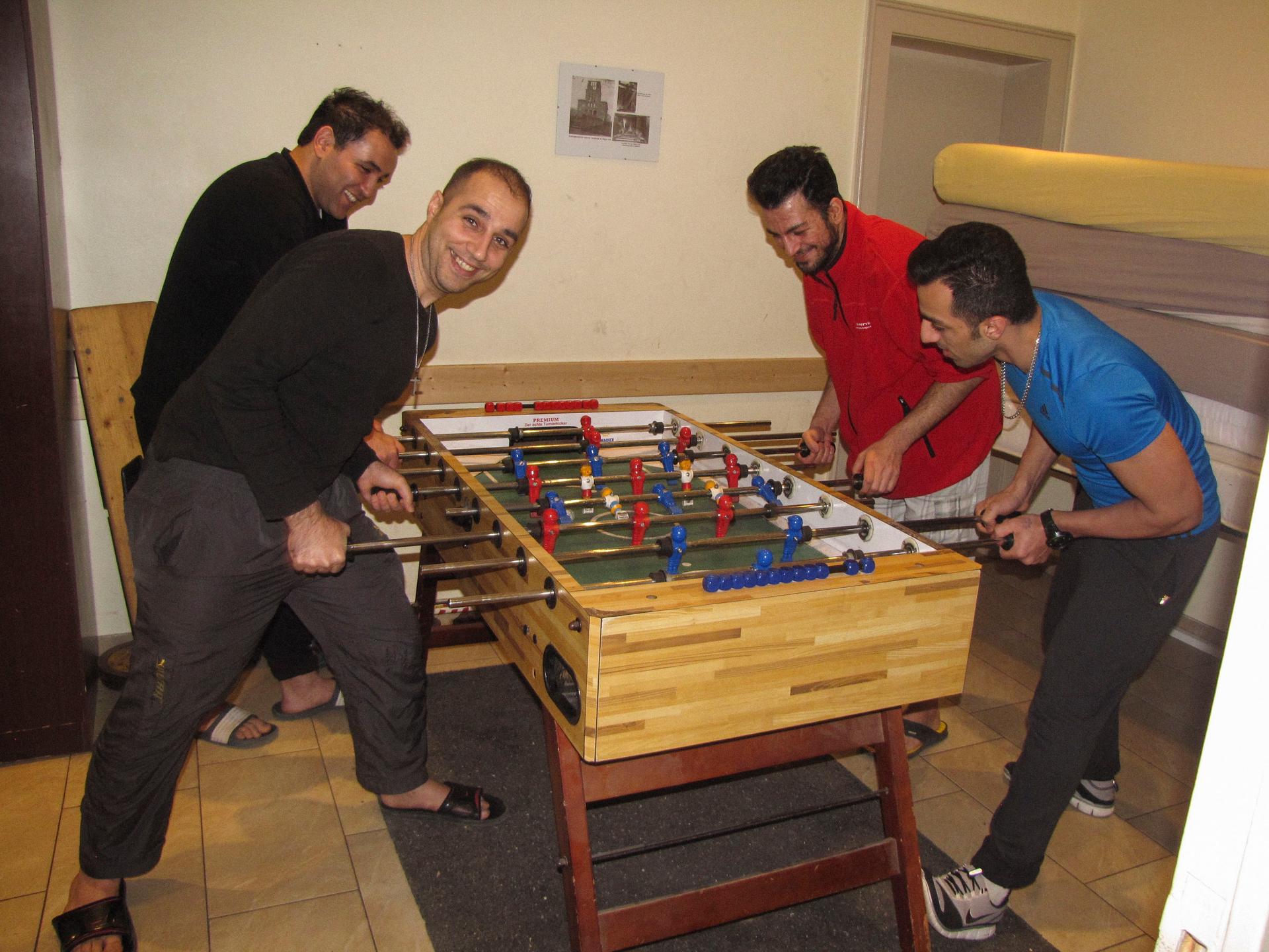 Foosball is one diversion for the residents of the Evangelical Lutheran Trinity Church and Community in Berlin. Left to right: Ali, Amir, Saeed and Ali.