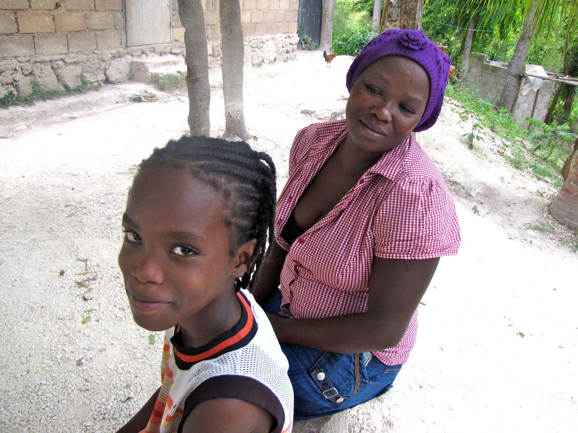 Frandy Calixte with his mother, Madame Frantz Calixte, outside their home.