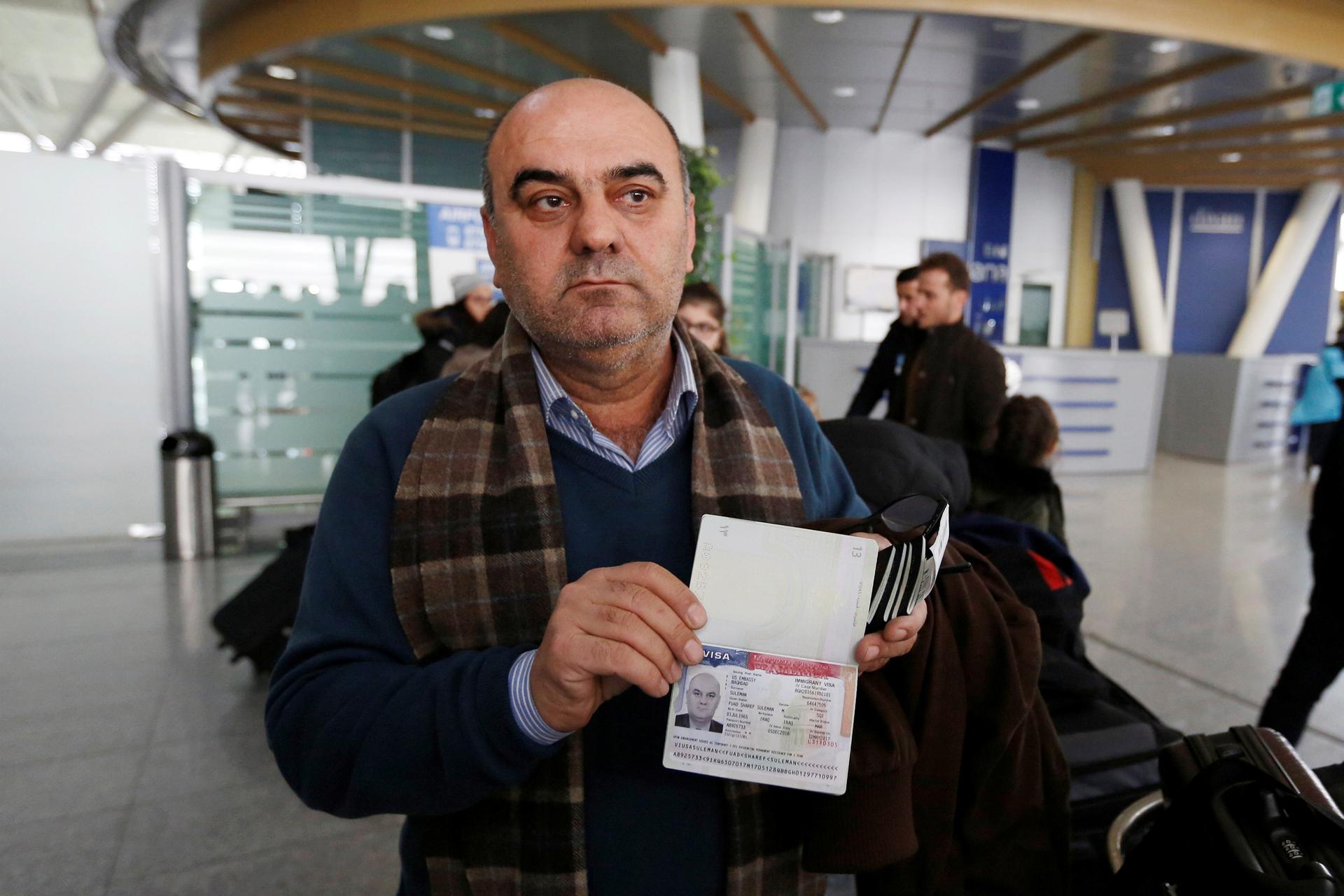 Fuad Sharef shows his US visa to the media at Erbil International Airport, after returning to Iraq from Egypt, Jan. 29, 2017.