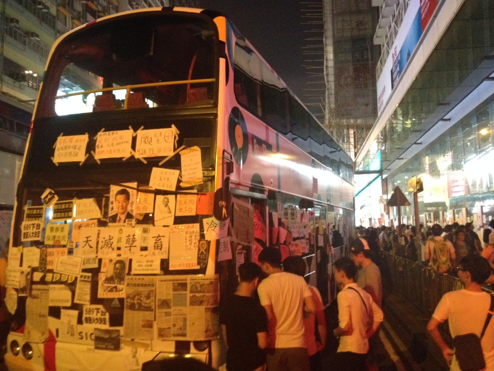 This Hong Kong bus, along with a few others, has been parked in the middle of a Mong Kok street since Sunday. It now serves as a 