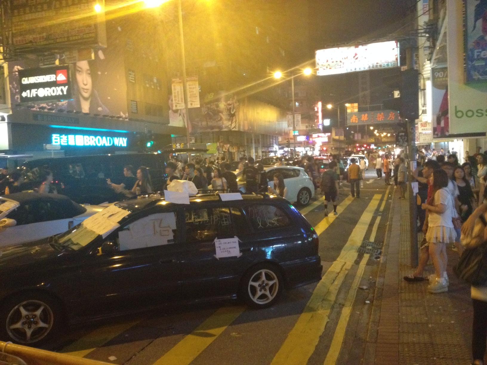 Private cars remain parked in a Mong Kok street blockading other vehicles from entering the protest zone.