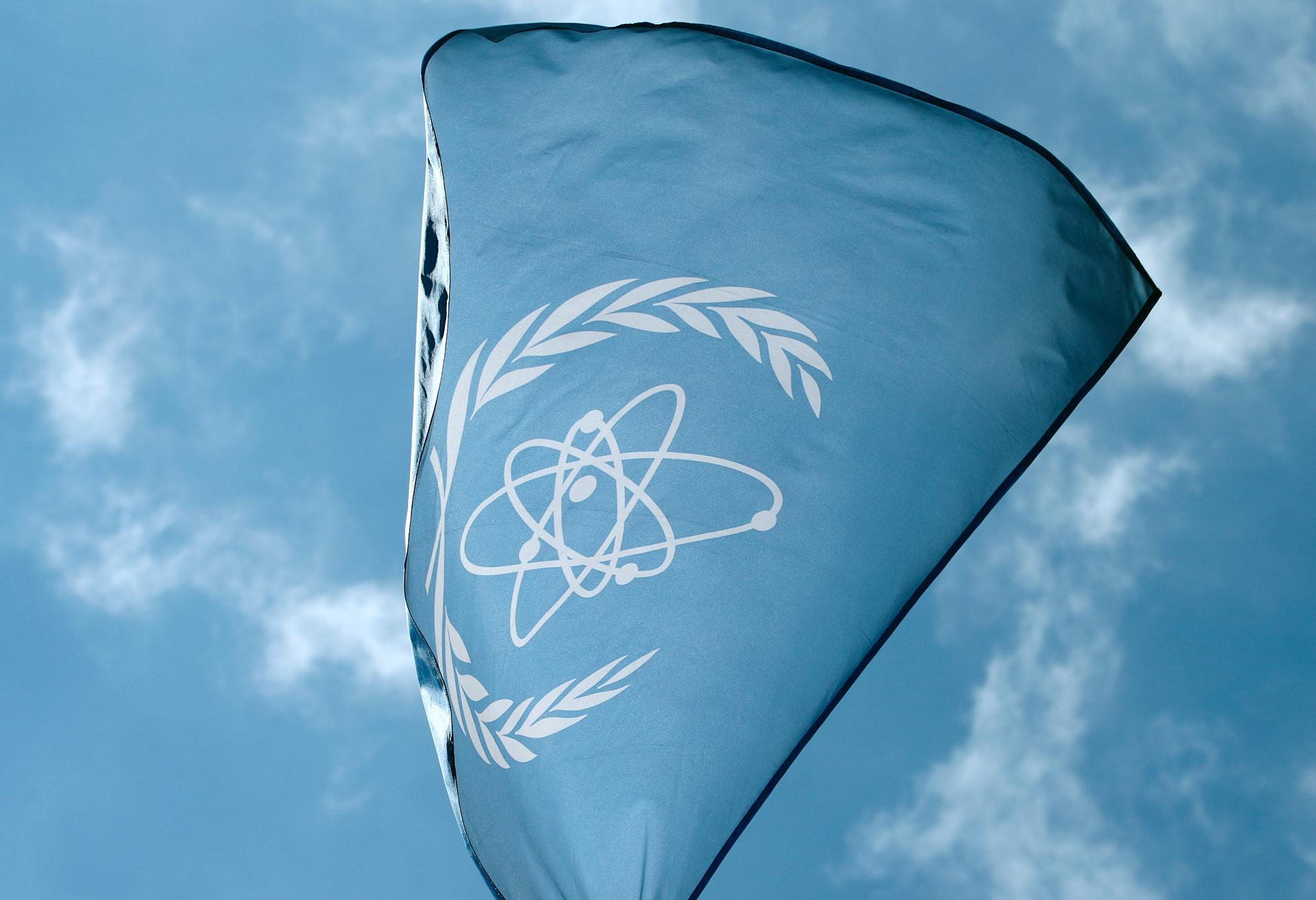 The flag of the International Atomic Energy Agency (IAEA) flies in front of its headquarters in Vienna, Austria, May 28, 2015