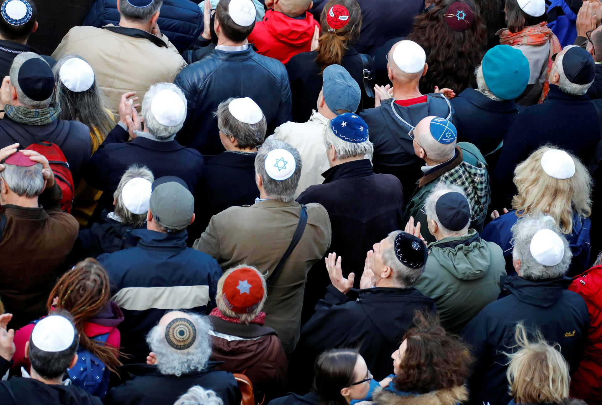 People from different faiths wear kippas as they attend a demonstration on April 25th in front of a Jewish synagogue, to denounce an anti-Semitic attack on a young man wearing a kippa in Berlin earlier in the month.
