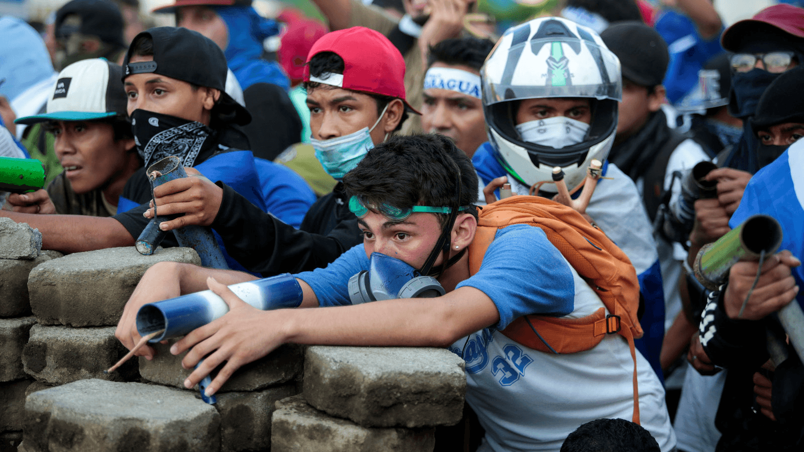 Nicarguan youth sit behind a barricated with homemade mortars as they fight the government.