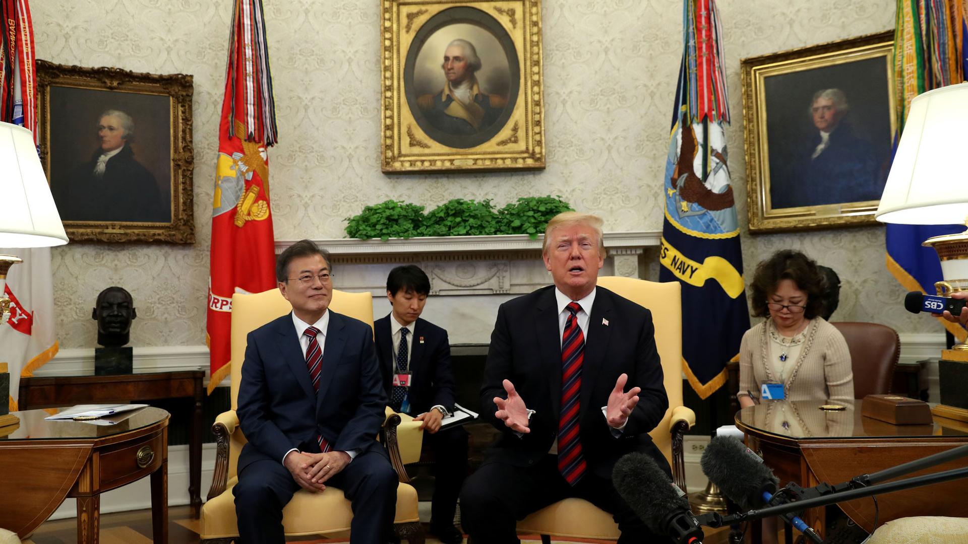 Donald Trump and Moon Jae-In sit in large chairs in the White House