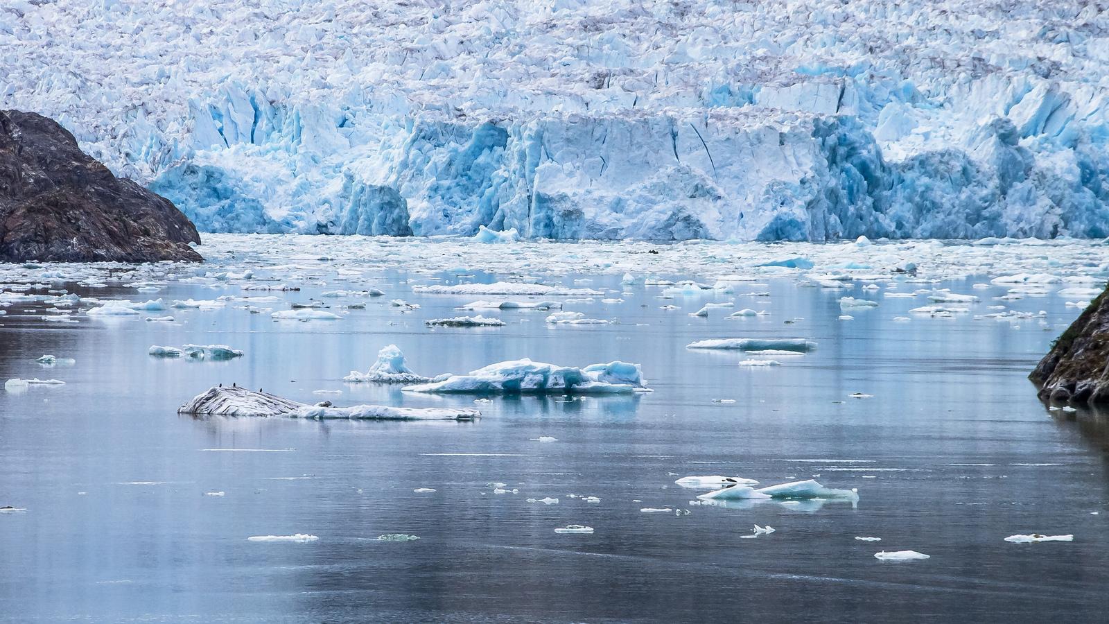 Bits of icebergs can be seen that have broken off the Sawyer Glacier in Alaska, where the effects of climate change are being felt at a higher rate than the Lower 48.