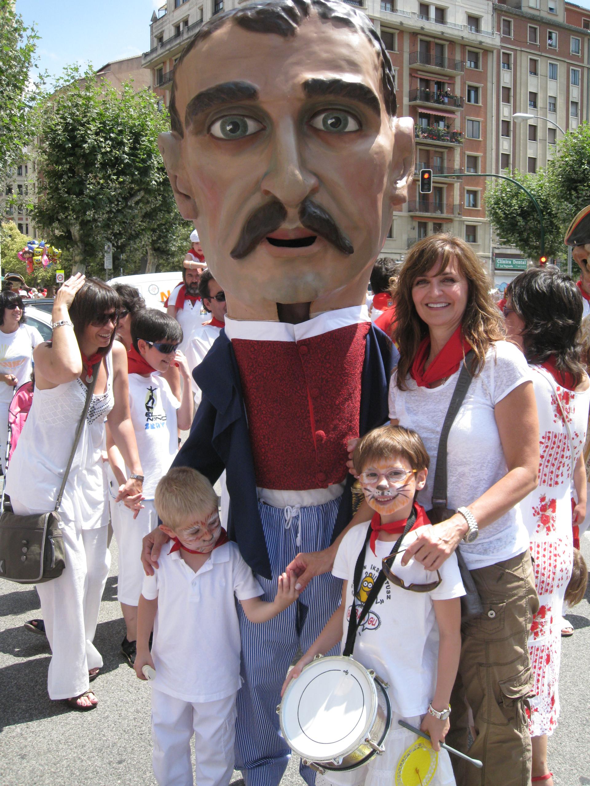Woman at festival posing with children with a man in costume