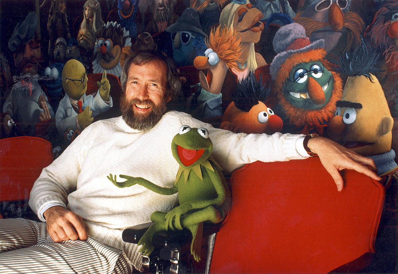 Jim Henson and his creation, Kermit the Frog, sit in front of a mural by Coulter Watt.