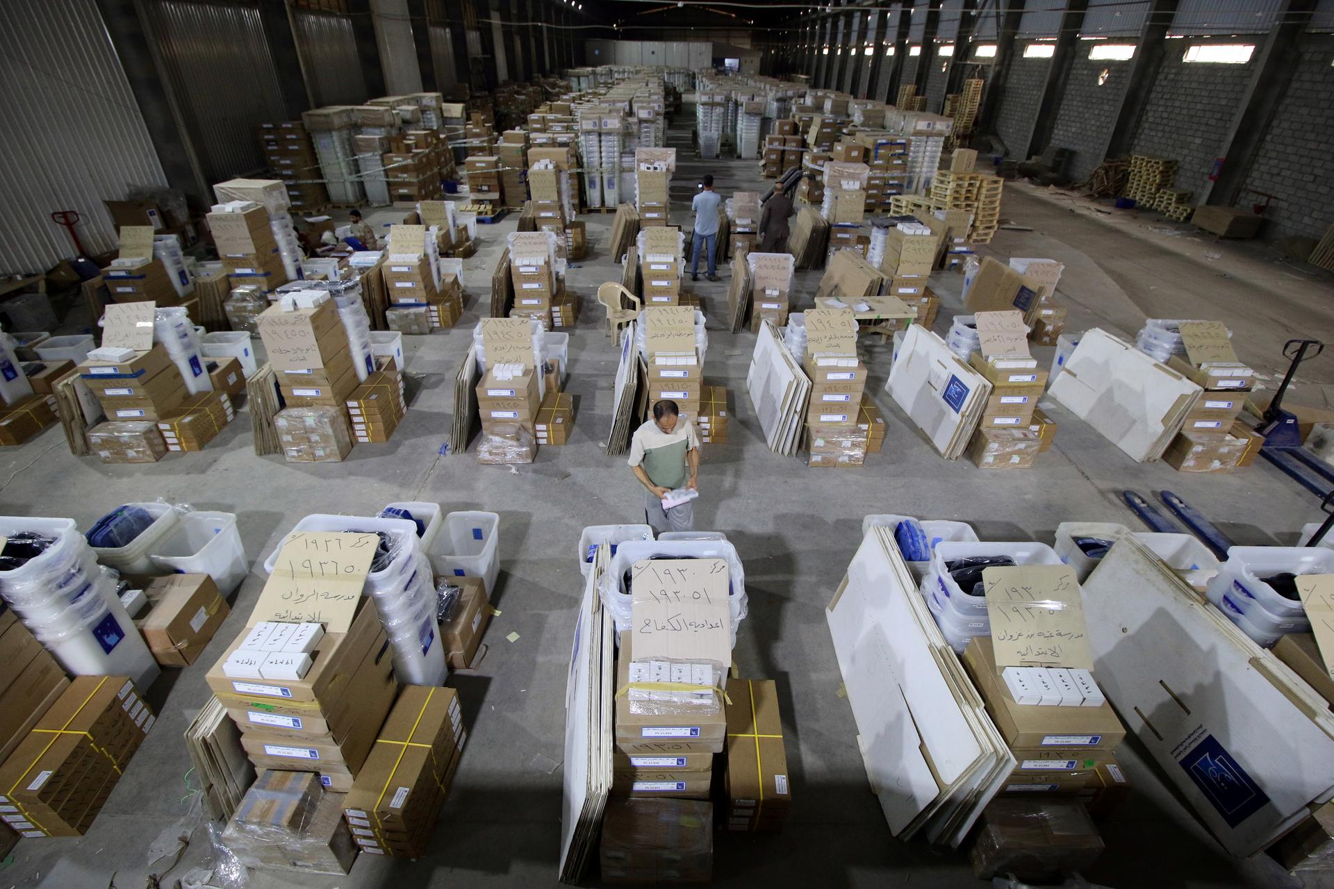Employees of Iraqi Independent High Electoral Commission inspect voting materials at a warehouse in Basra, Iraq, May 3, 2018.