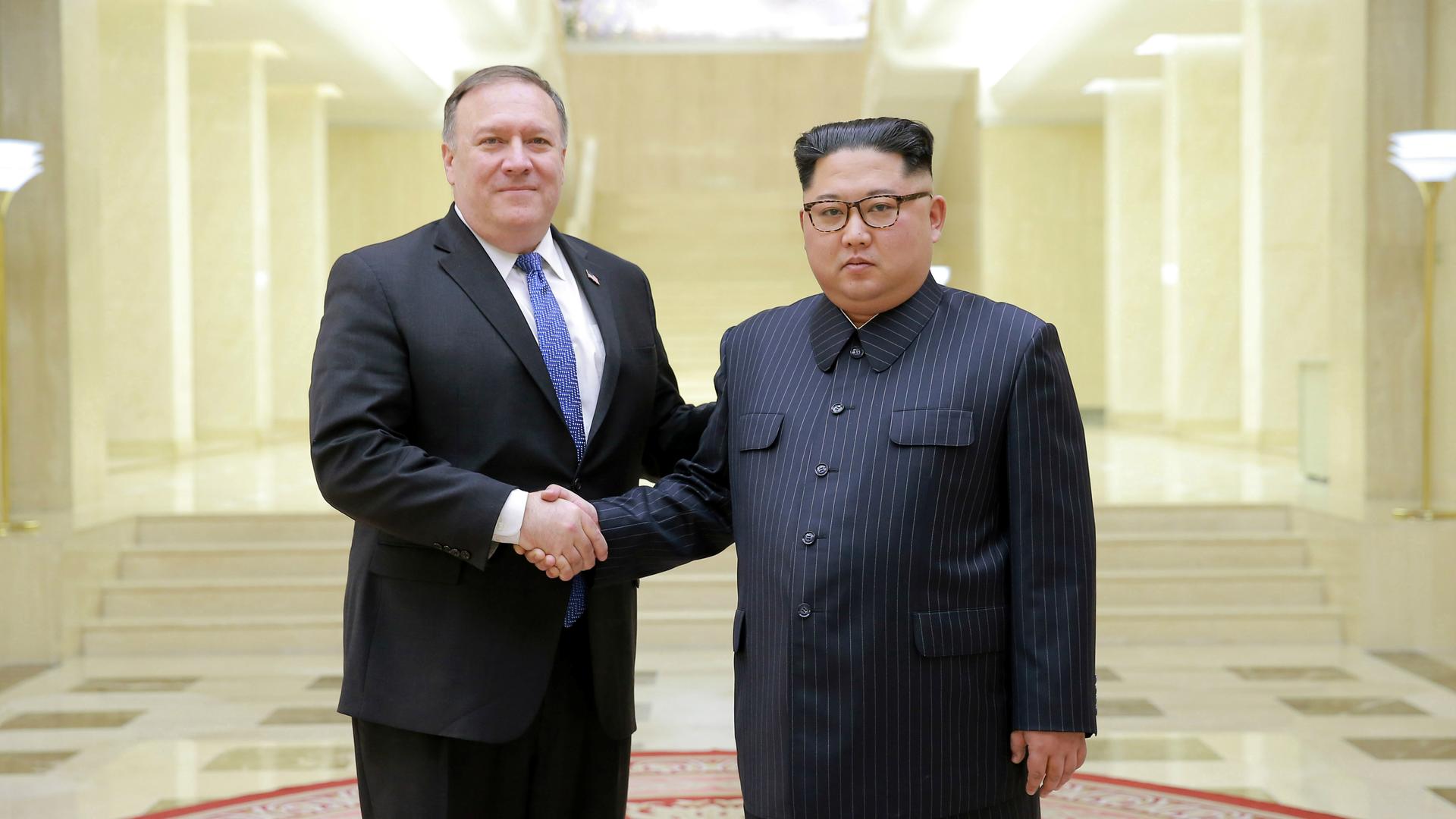North Korean leader Kim Jong Un shakes hands with US Secretary of State Mike Pompeo in this undated photo released on May 9, 2018, by North Korea's Korean Central News Agency in Pyongyang. The same day, North Korea released three American prisoners, pavin