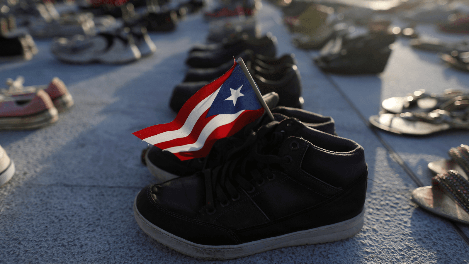 Shoes at Puerto Rico's capitol building represent the more 4,645 deaths attributed to Hurricane Maria