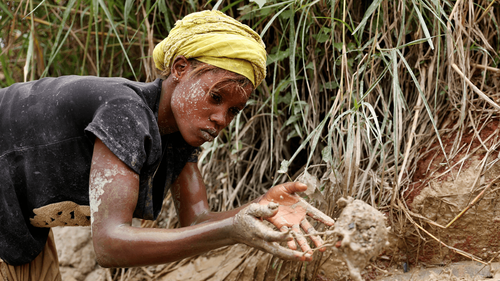 a woman working in a gold mine in the DRC