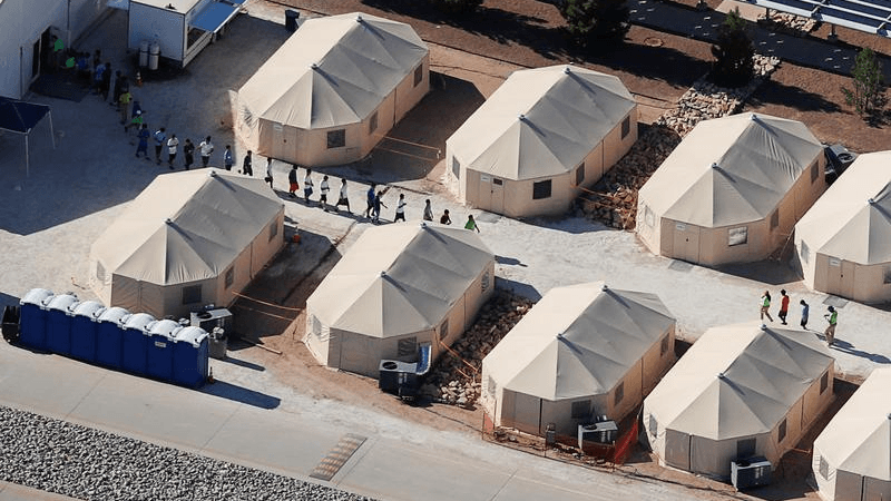 an aerial view of a tent camp for detained migrant children in the US