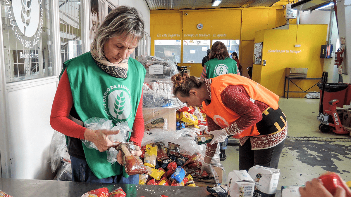 volunteers pack food at a food bank in Buenos Aires, Argentina