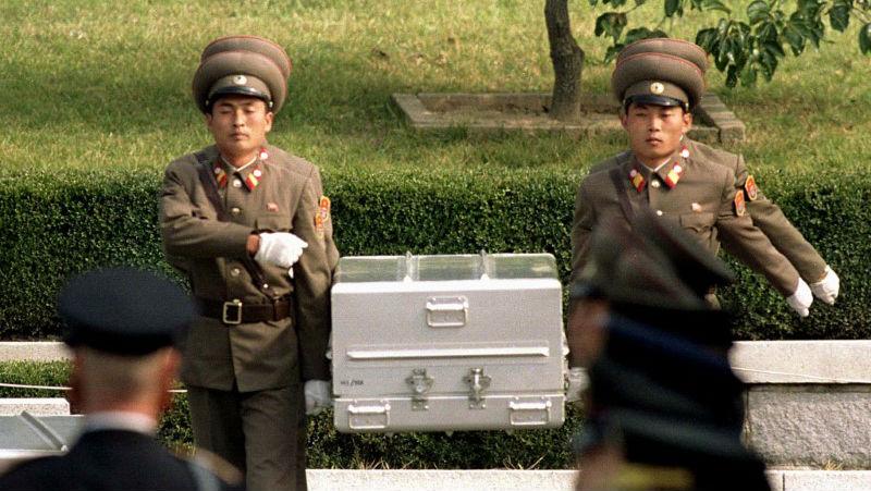 North Korean soldiers carry a coffin believed to contain the remains of a US soldier to the border with South Korea during repatriation ceremonies at the truce village of Panmunjom, South Korea, October 9, 1998.